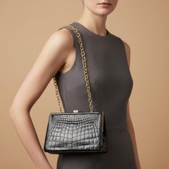 An Elegant 1950s Retro Black Leather and Brass Italian Shoulder Bag