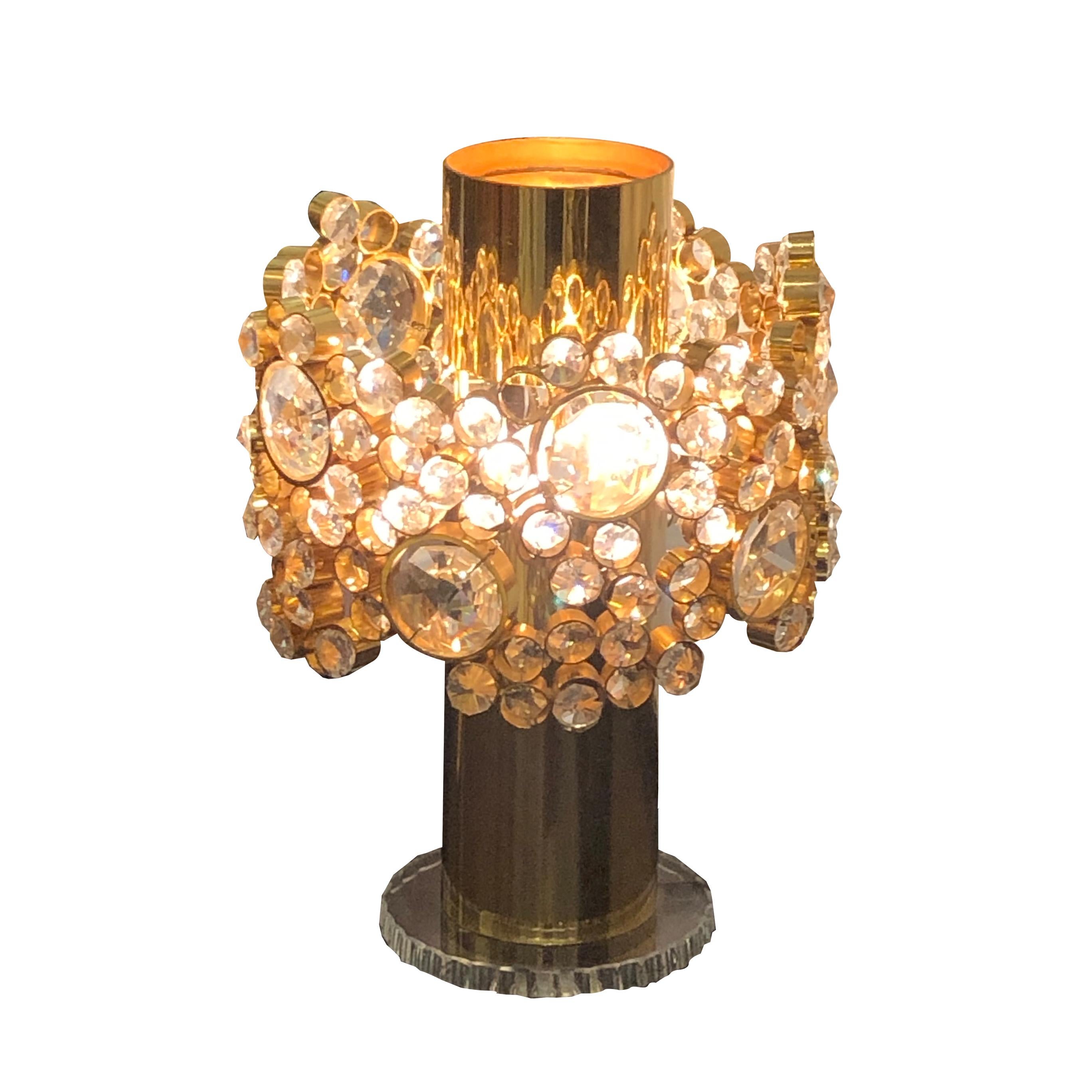 A rare model 1960s Austrian table lamp by J.L. Lobmeyr. The lamp's brass shaft is presented on a clear glass base. This is a very elegant design with a removable crown adorned with cut crystals to allow space to change the light bulbs. 

Size: H: