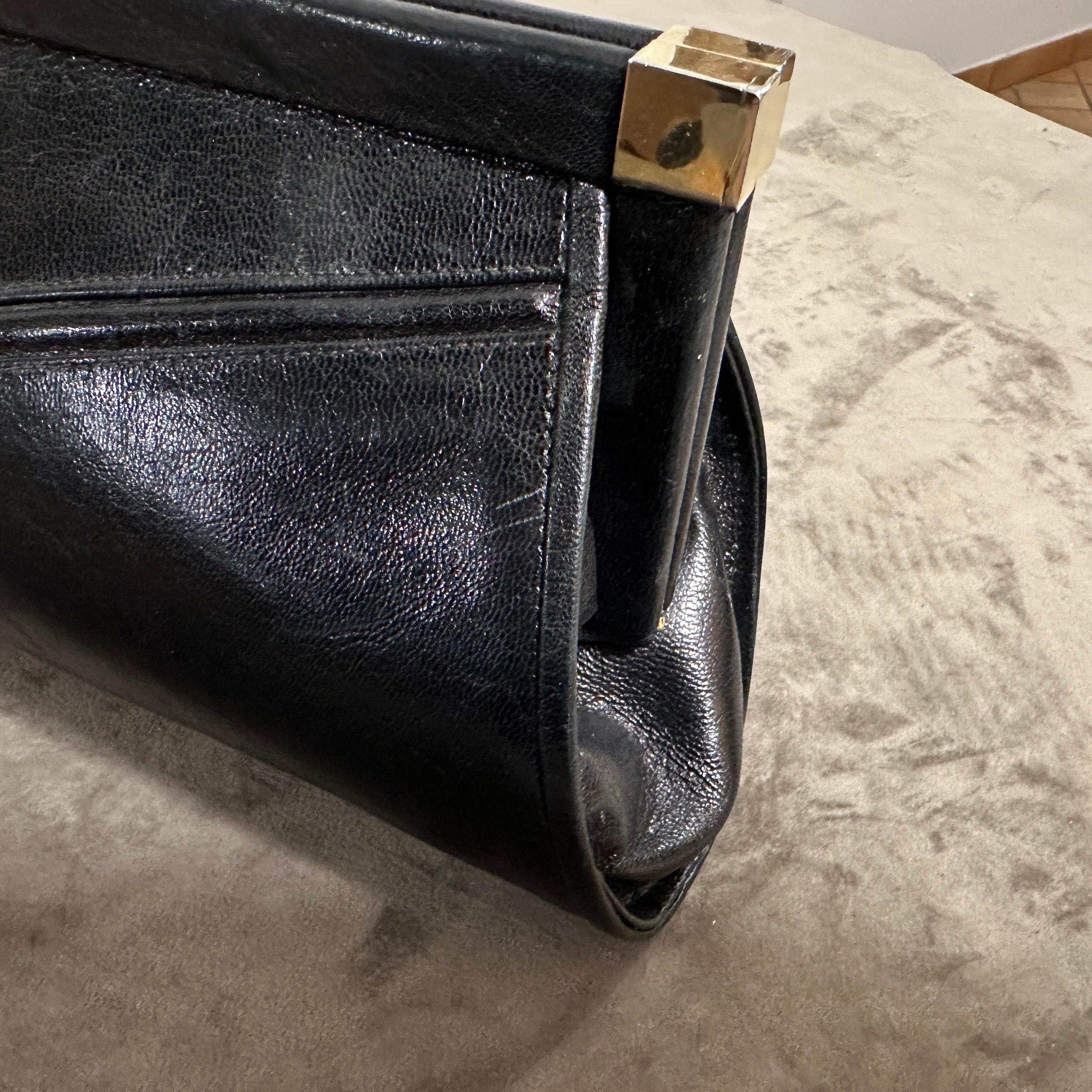 This bag is effortlessly chic—ideal for vintage lovers or anyone looking to add a touch of classic Italian glamour to their outfit and is a sleek and timeless piece. Crafted from black leather, the bag has a smooth, slightly glossy finish that gives