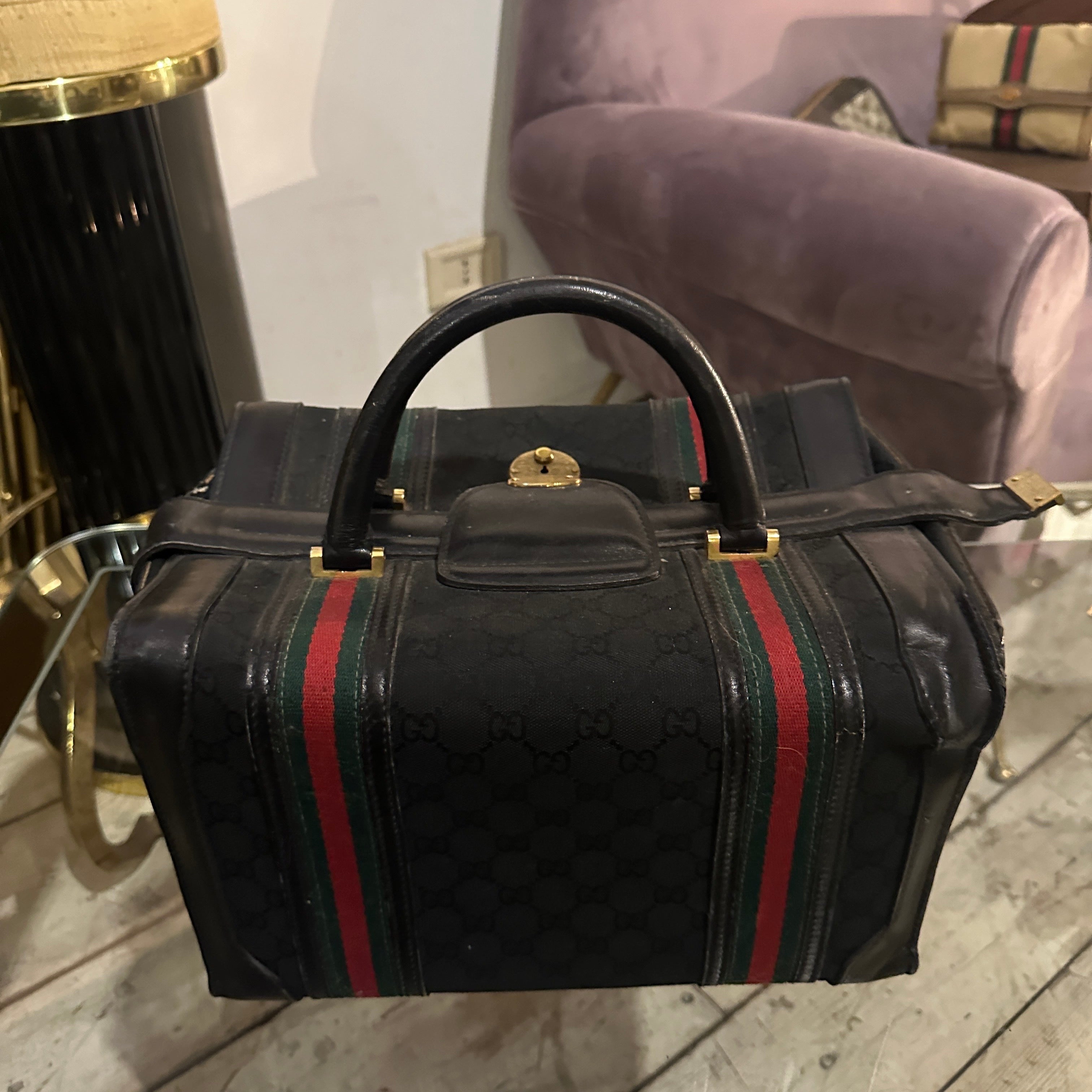 This iconic Gucci travel bag is a timeless masterpiece that blends luxury with functionality, perfect for discerning travelers. Crafted from Gucci’s signature black canvas featuring the iconic GG monogram, it is complemented by leather accents that