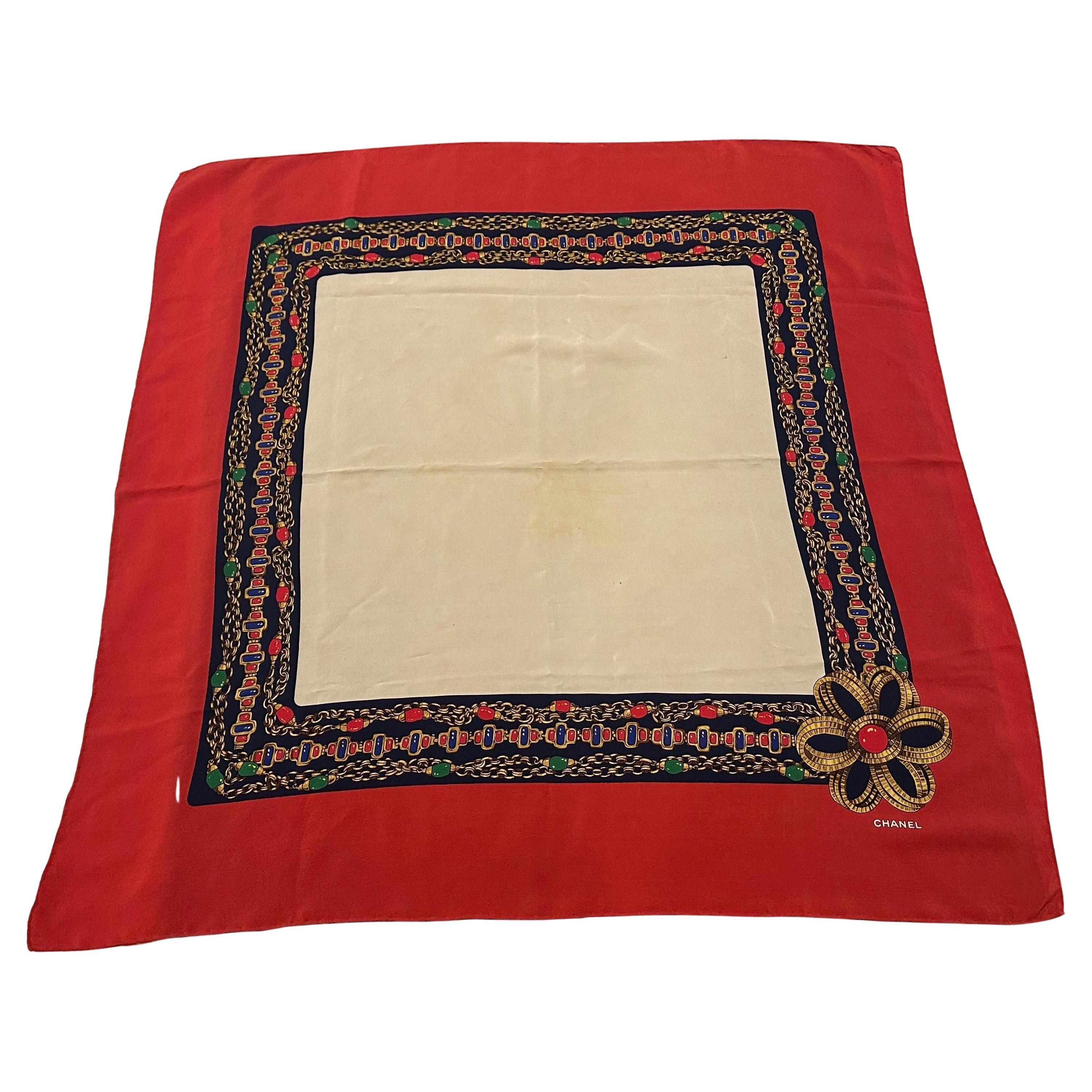 Discover a timeless piece of fashion history with this exquisite 1980s silk carré scarf by the iconic French fashion house, Chanel. This elegant accessory embodies the sophisticated glamour and meticulous craftsmanship for which Chanel is
