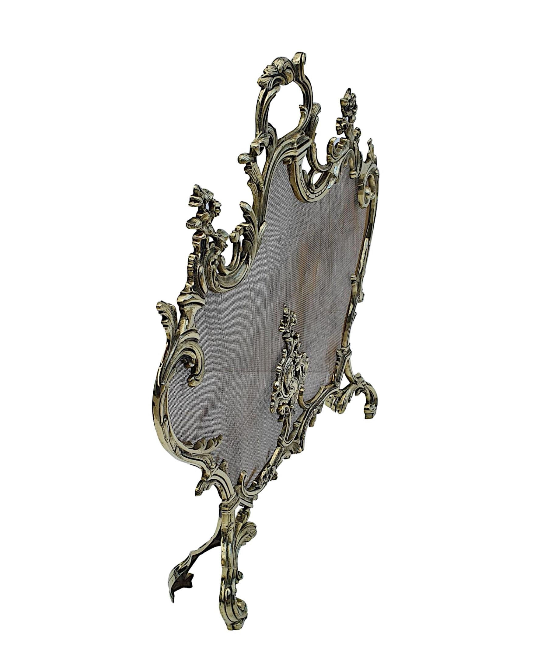 An elegant 19th Century fully restored brass fires creen in the Rococo manner. The shaped wire mesh is set within a beautifully cast pierced brass frame with intricate scrolling foliate, flowerheads, s and c scroll motif detail throughtout,