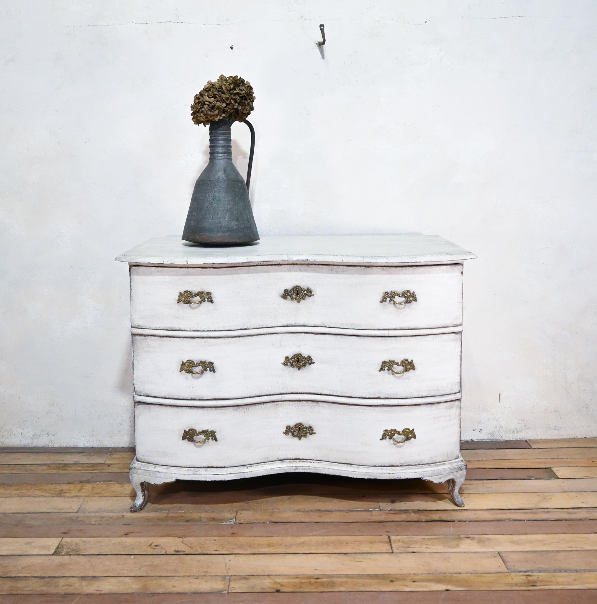 A striking large scale 19th century German Rococo painted commode. Displaying an elegant double bowfront outline, with a gracefully shaped top, raised on charming cabriole feet. Featuring period white later paint from some point during the early