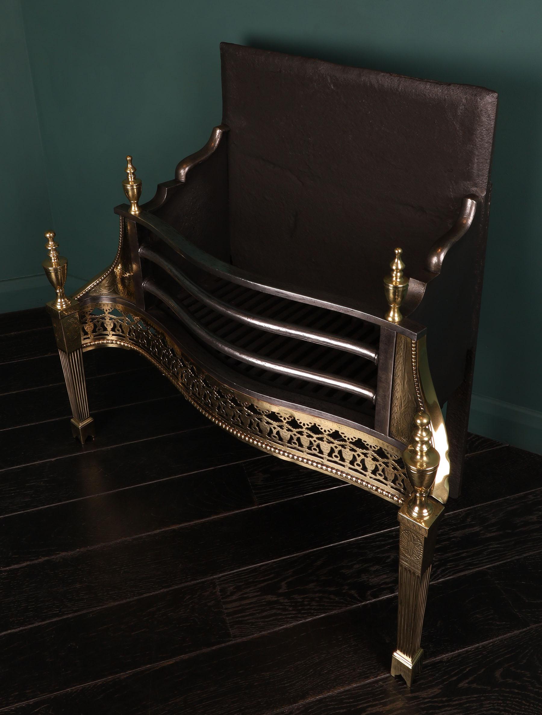 An elegant brass & steel serpentine fire grate by Longden. The railed basket supported by tapered uprights on arched plinthed feet. The ornate frieze consisting of engraved urns and palmettes set over beaded moulding. Intricate engraving to wings