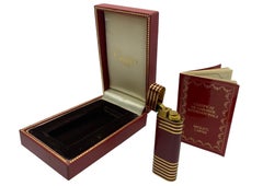 An Elegant Cartier Gold Plated Striped Burgundy Lacquer Finish Art Deco Design