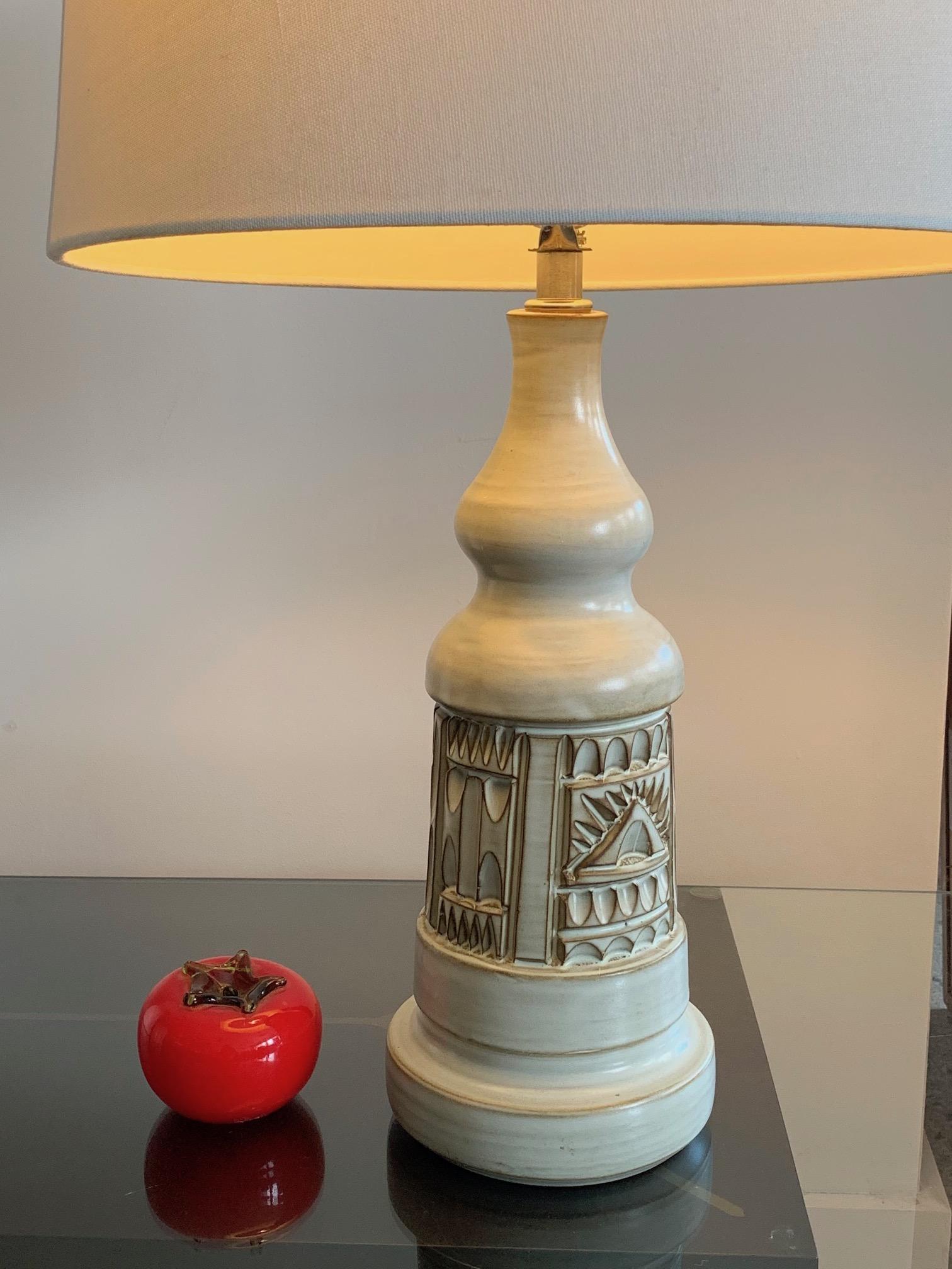 A charming lamp by Marius Bessone, Vallauris, France. Beautiful off-white glaze with stylized geometric motif, typical of his work from late 1960s-1970s. Ceramic base alone measures approximate: 14.5