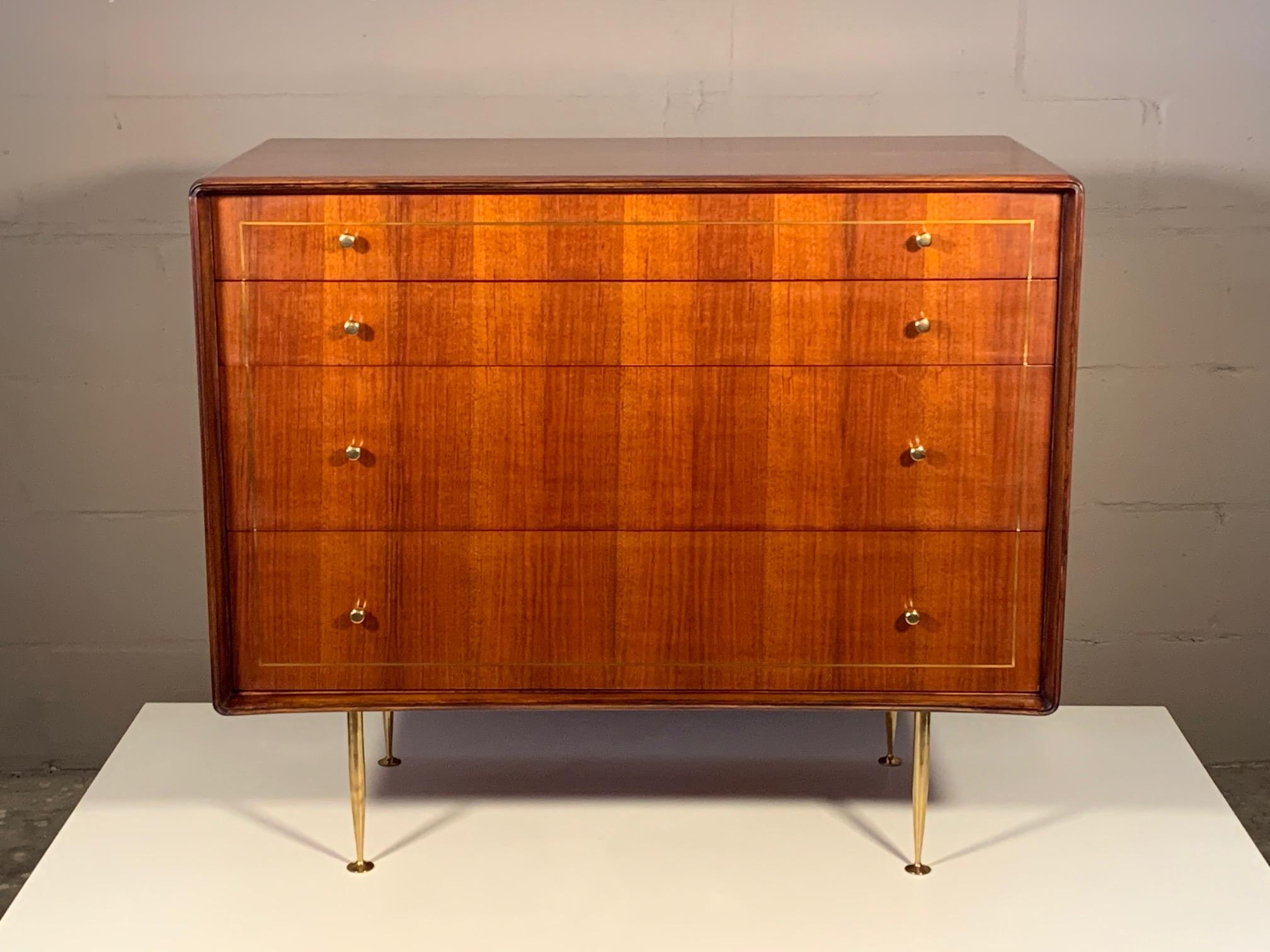 An elegant and refined chest of drawers by Erno Fabry. Made in Italy with solid brass, polished hardware and legs. Walnut construction with unusual curved front and picture frame design with brass inlay in the front drawers. Completely restored and