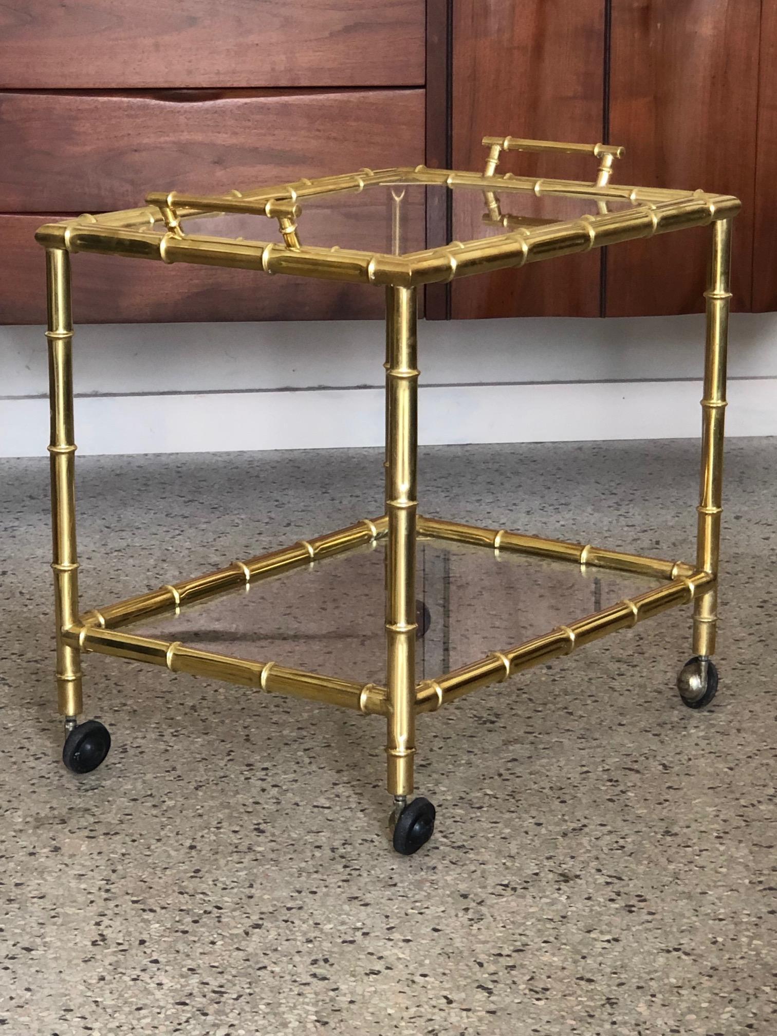 A stylish French bar cart or drinks trolley. Clever design allows for top to lift off and become a serving tray. Faux bamboo-very well made, vintage ca' 1970's, in the style of Bagues or Jansen.