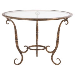 Un elegante tavolo con piano in ferro dorato e vetro, forse di Giovanni Banci, C.C. 1970.