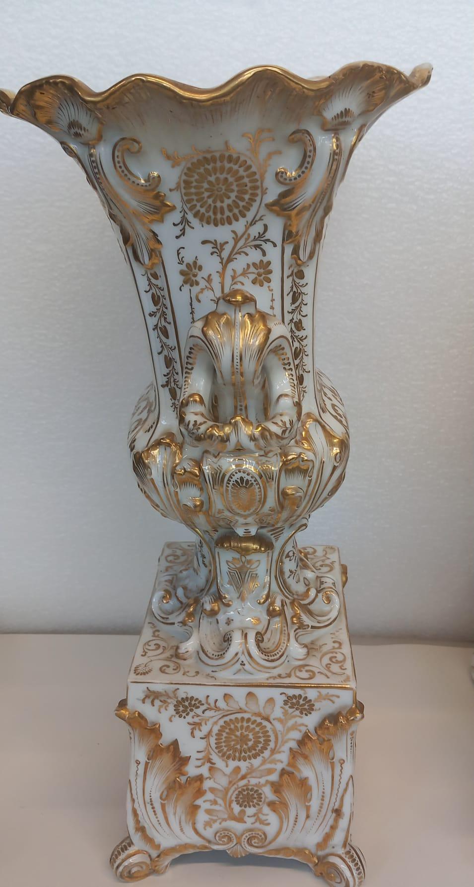 An elegant mantle piece clock with its accompanying vases made in Paris circa 1860. Very much in the Jacob Petit style and most probably from his factory, each piece is elaborately gilded and hand painted with cartouches of flowers.
The scene is a