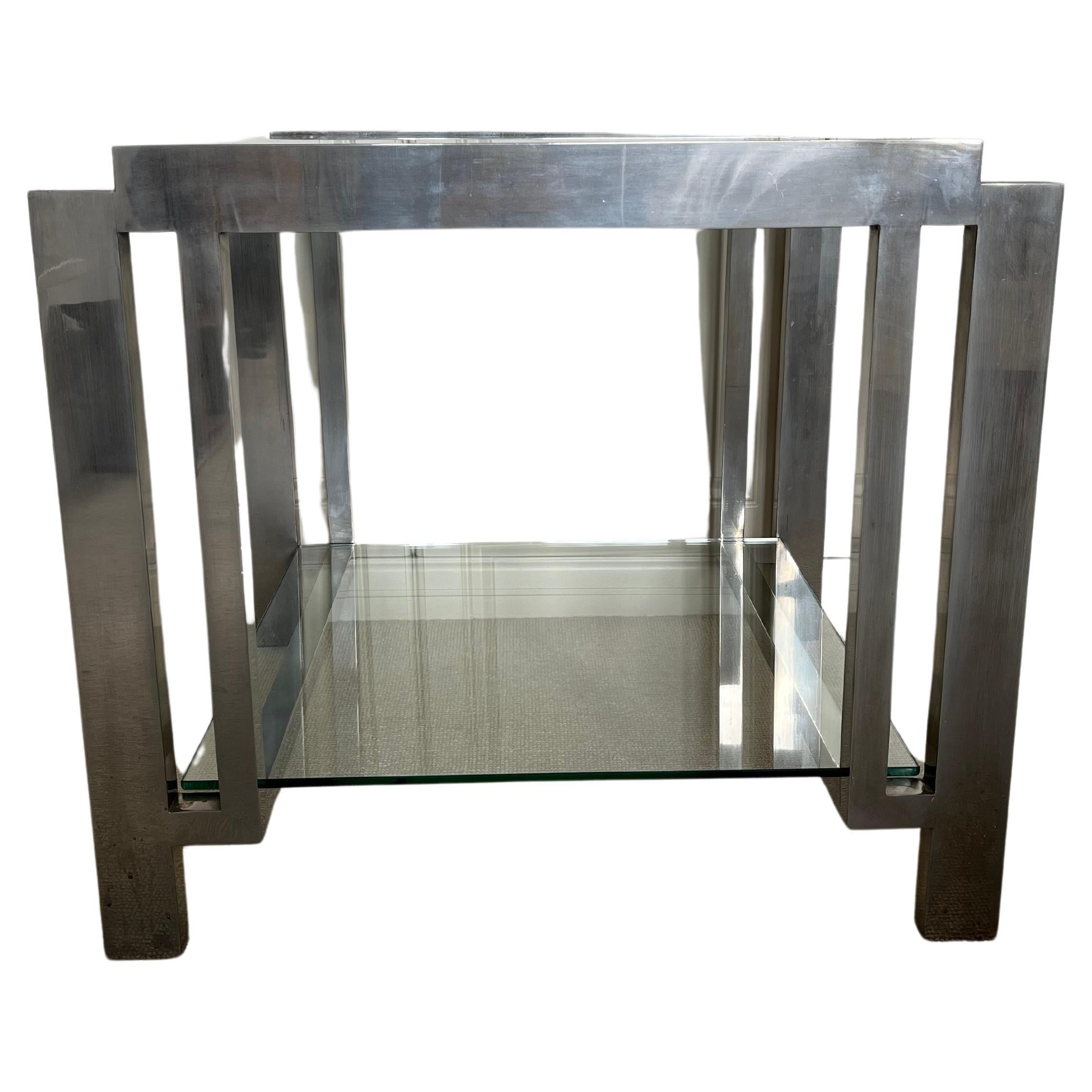 An elegant modernist nickel on brass two tier side table