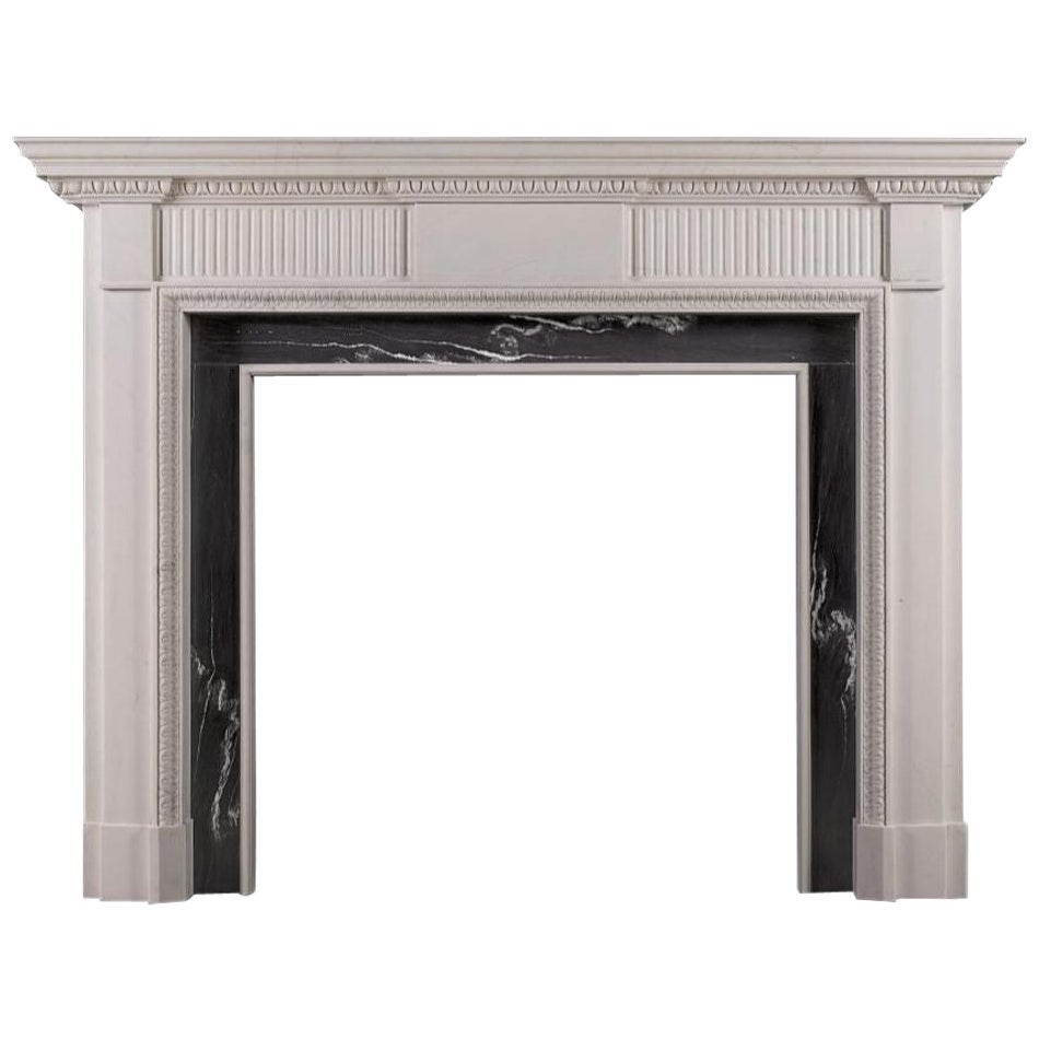An elegant neoclassical style limestone fireplace, reflecting the designs of the For Sale