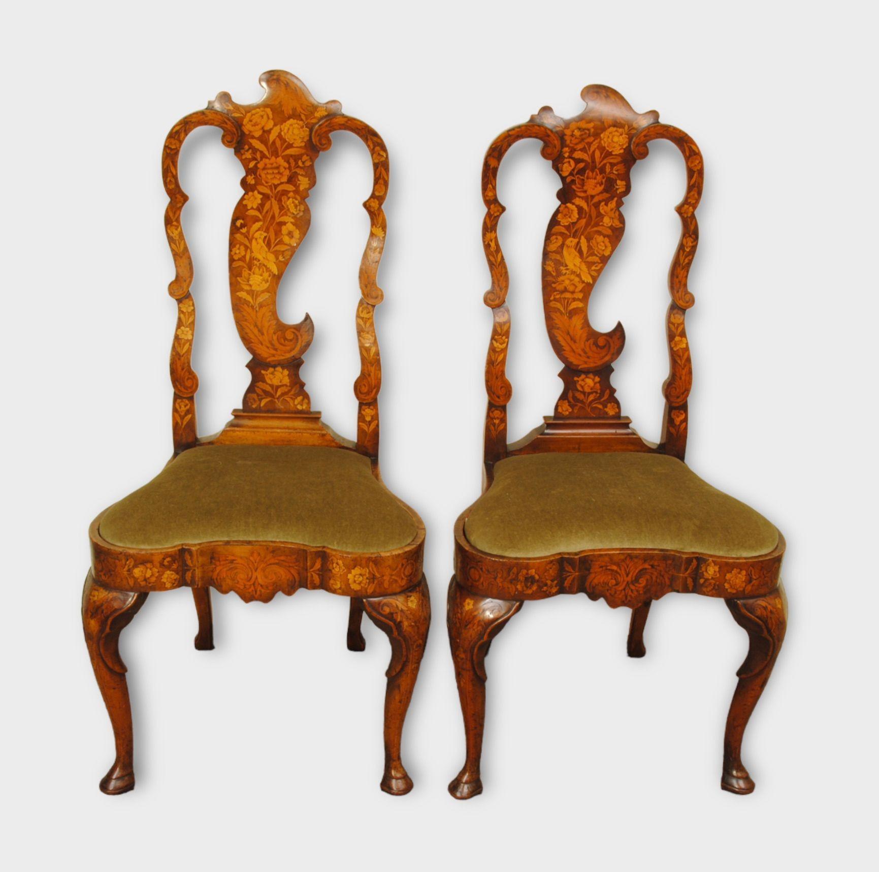 A pair of 18th century dutch walnut and marquetry inlaid side chairs with floral design and birds in the back splat, standing on cabriole legs. Good colour and patination. Circa 1775 