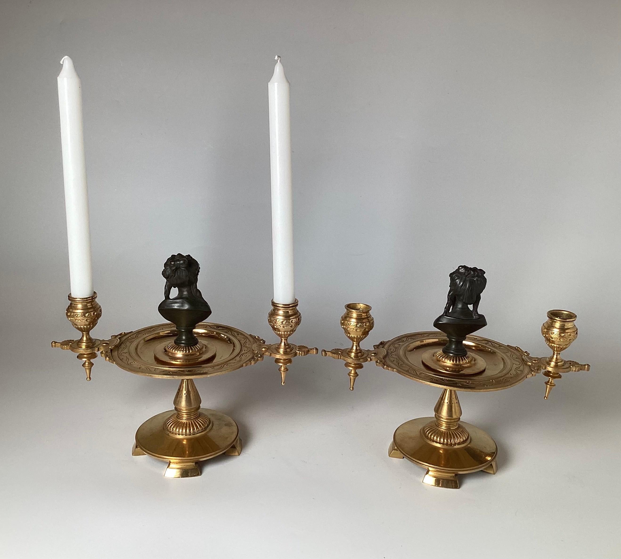 An elegant pair of antique French, guilt and patinated bronze figure candelabra from the 1870s the pair with two different patinated bronze bust centers with the rest in its brilliant original gilt finish.   9.5 inches tall, 11.5 inches wide.  The