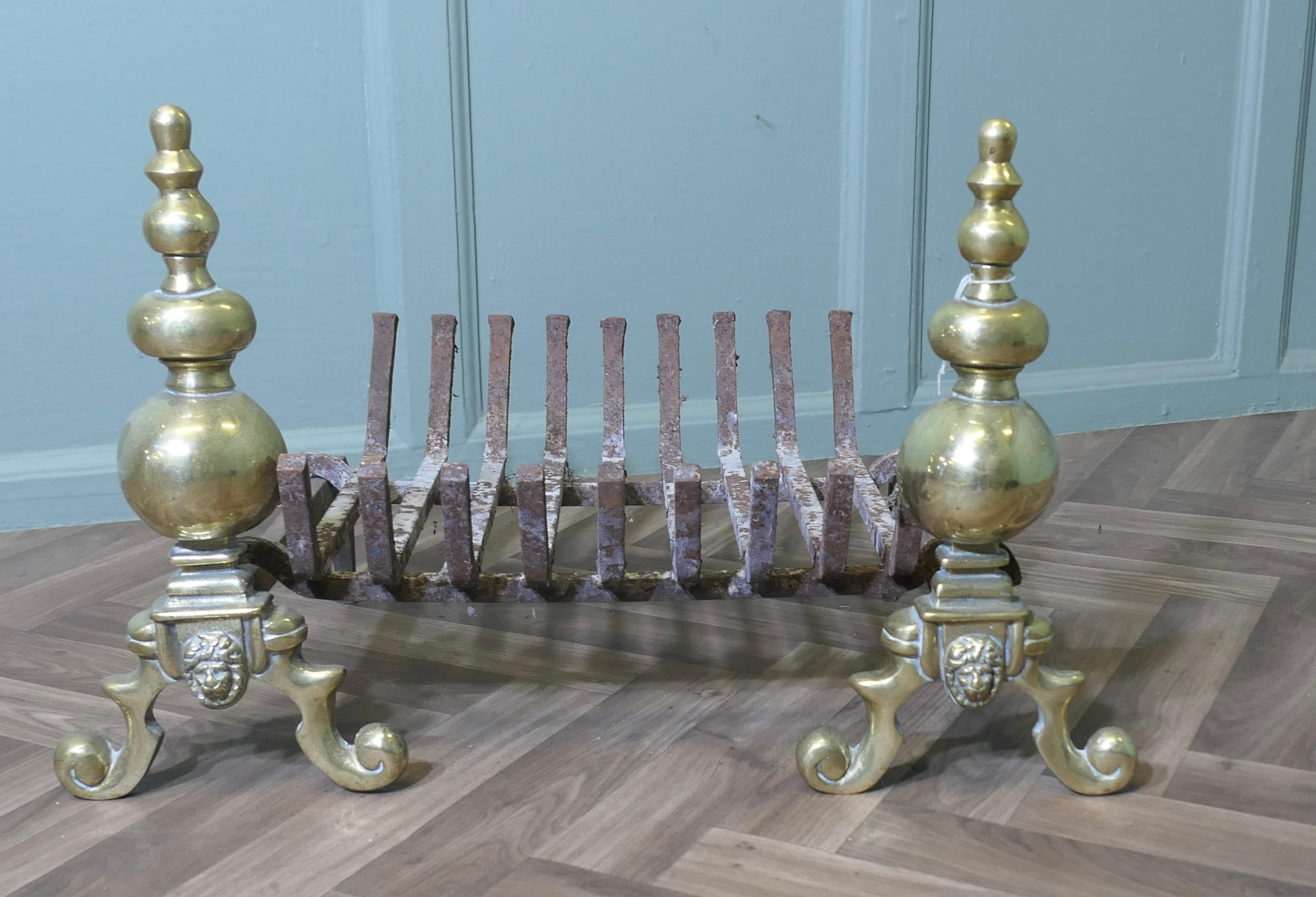An Elegant Pair of Brass Andirons Complete with Grate 

This is a good quality pair of Brass Andirons and they come with their original log grate
They are all in excellent antique condition and ready for use
The Grate is 15” high, 34” long and 15”