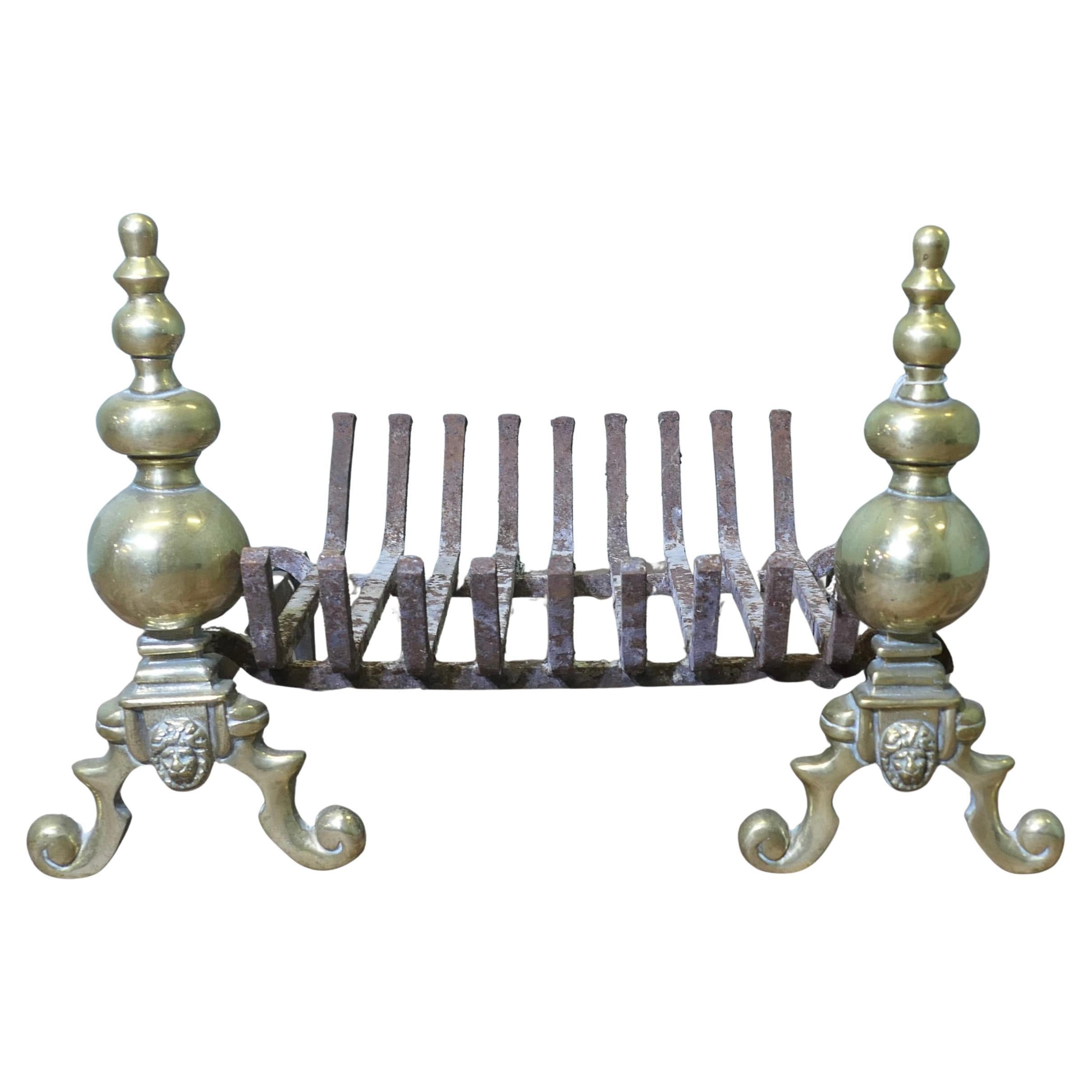 An Elegant Pair of Brass Andirons Complete with Grate For Sale
