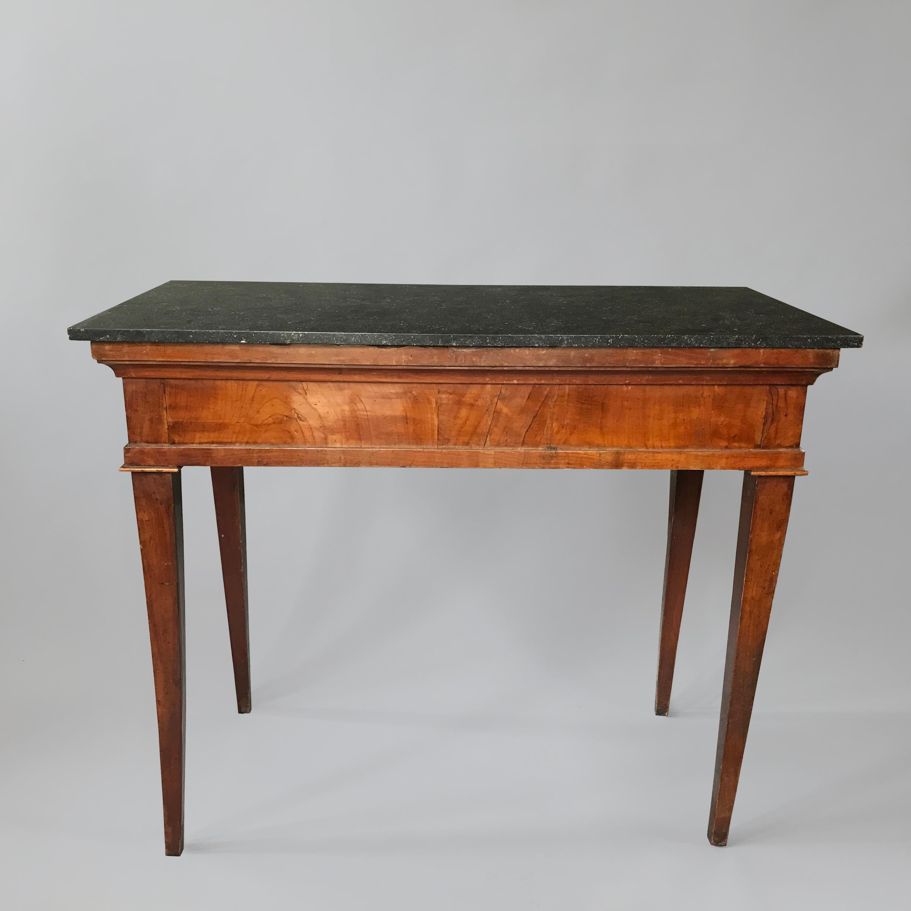 A smart pair of early C19th Italian walnut console tables with Belgium fossil marble tops standing on stylish tapered legs.