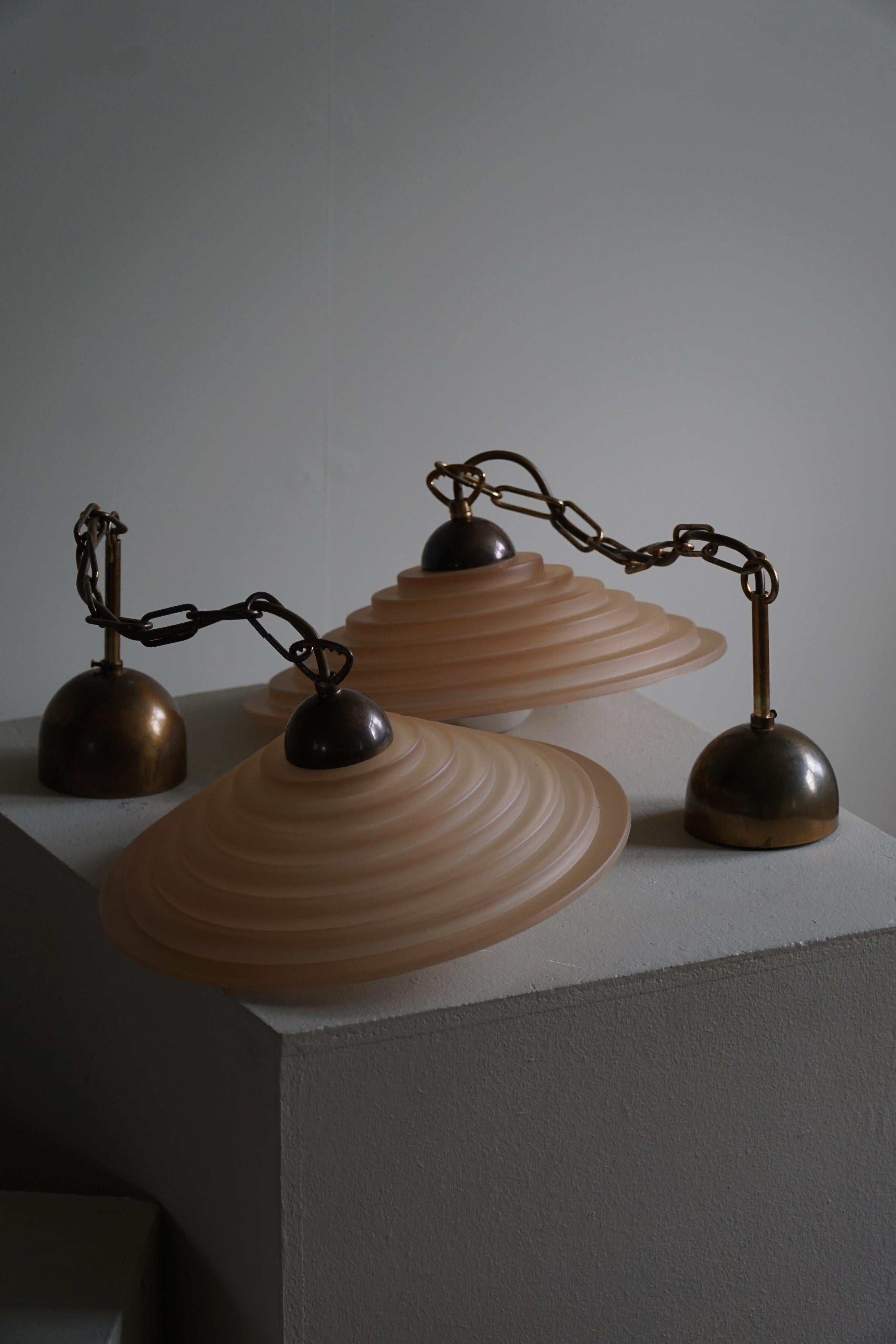 A charming pair of pendant lights in pink glass. Made in Denmark in the early 1900s.

The pair remains in really good condition. These beautiful vintage lights will complement many modern interior styles. A Modern, Scandinavian, Bohemian, Classic or