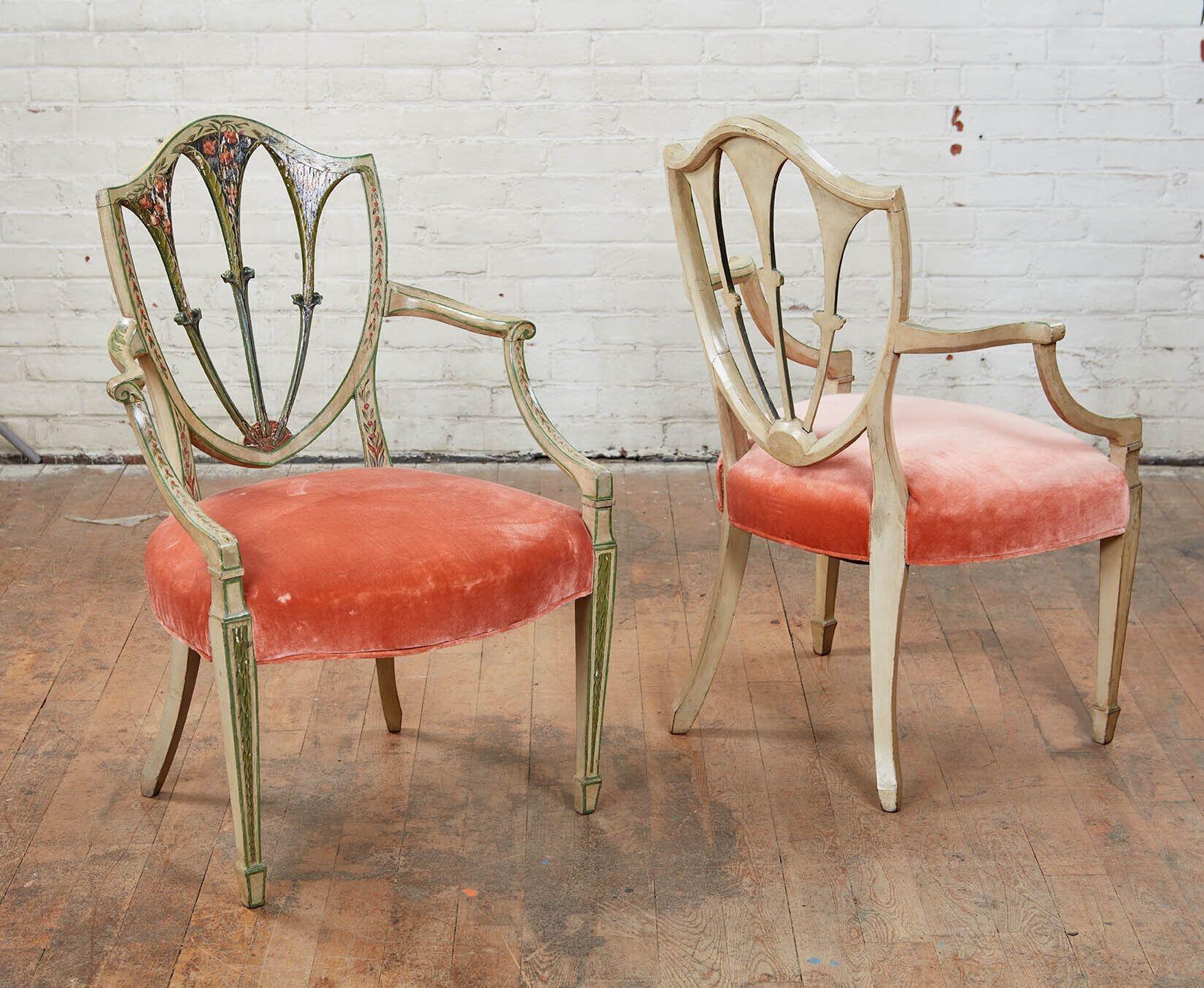 A pair of 18th century English Hepplewhite armchairs of generous scale with elegant proportions perfect for a bedroom, sitting room living room. Still retaining elements of their original hand painted decoration of garlands and rope. Seats in old