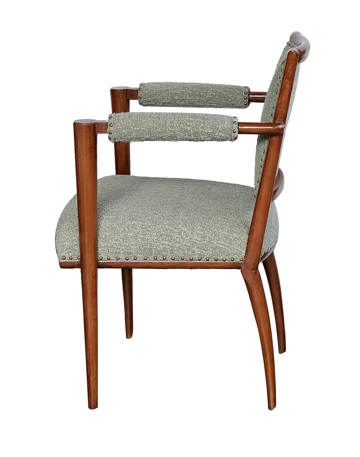 each of graceful art deco design with gently incurved upholstered back flanked by padded arms joining conical terminals; all above a tight seat raised on tuned supports