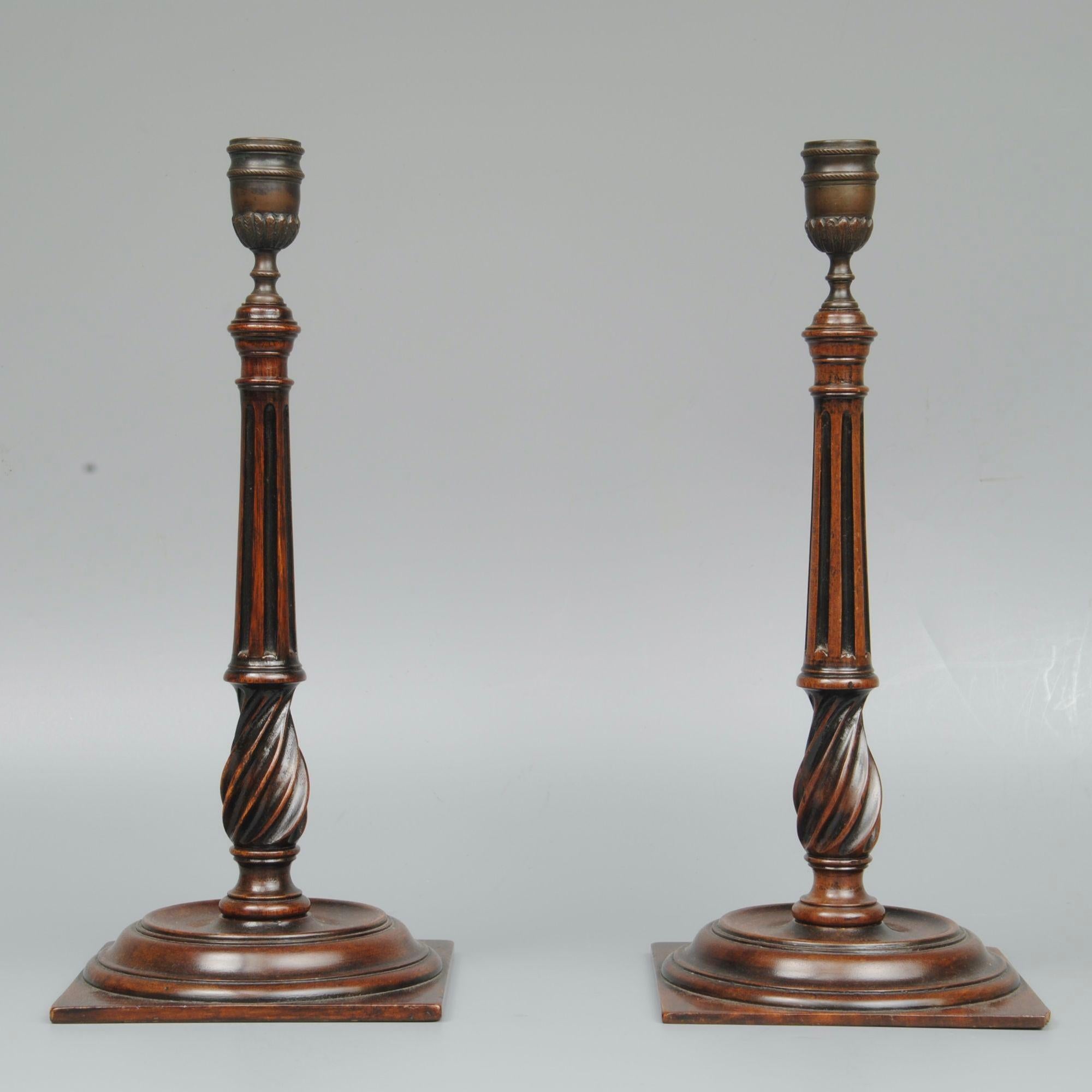 An elegant pair of mahogany turned and reeded 18th century style candlesticks with brass candle holders.
circa 1870