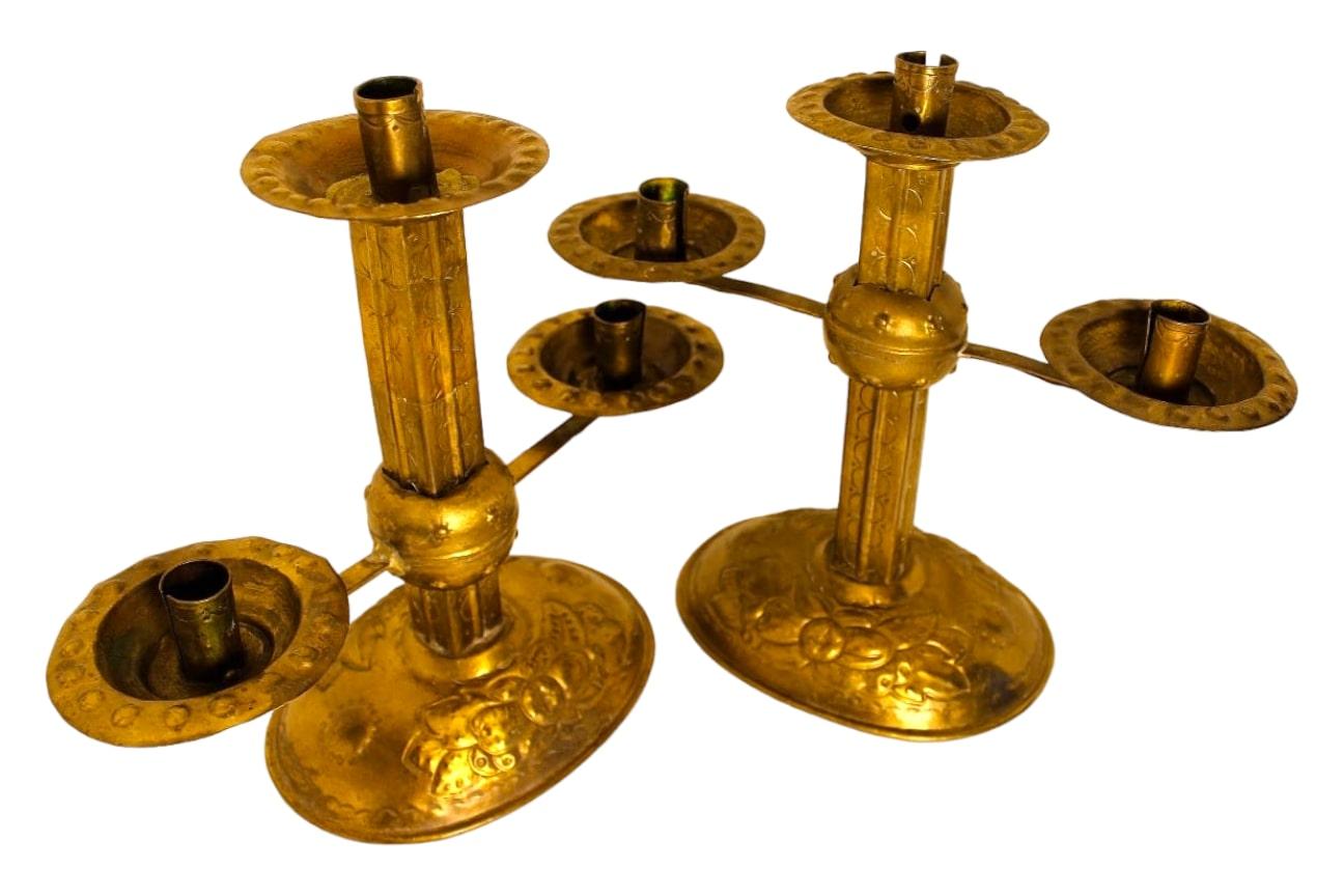 Crafted with intricate detailing, each candlestick allows the arms to be raised and lowered to the desired height, showcasing both functionality and artistic flair. In remarkably good condition, these candlesticks measure 32x28x14 cm.

The gilded