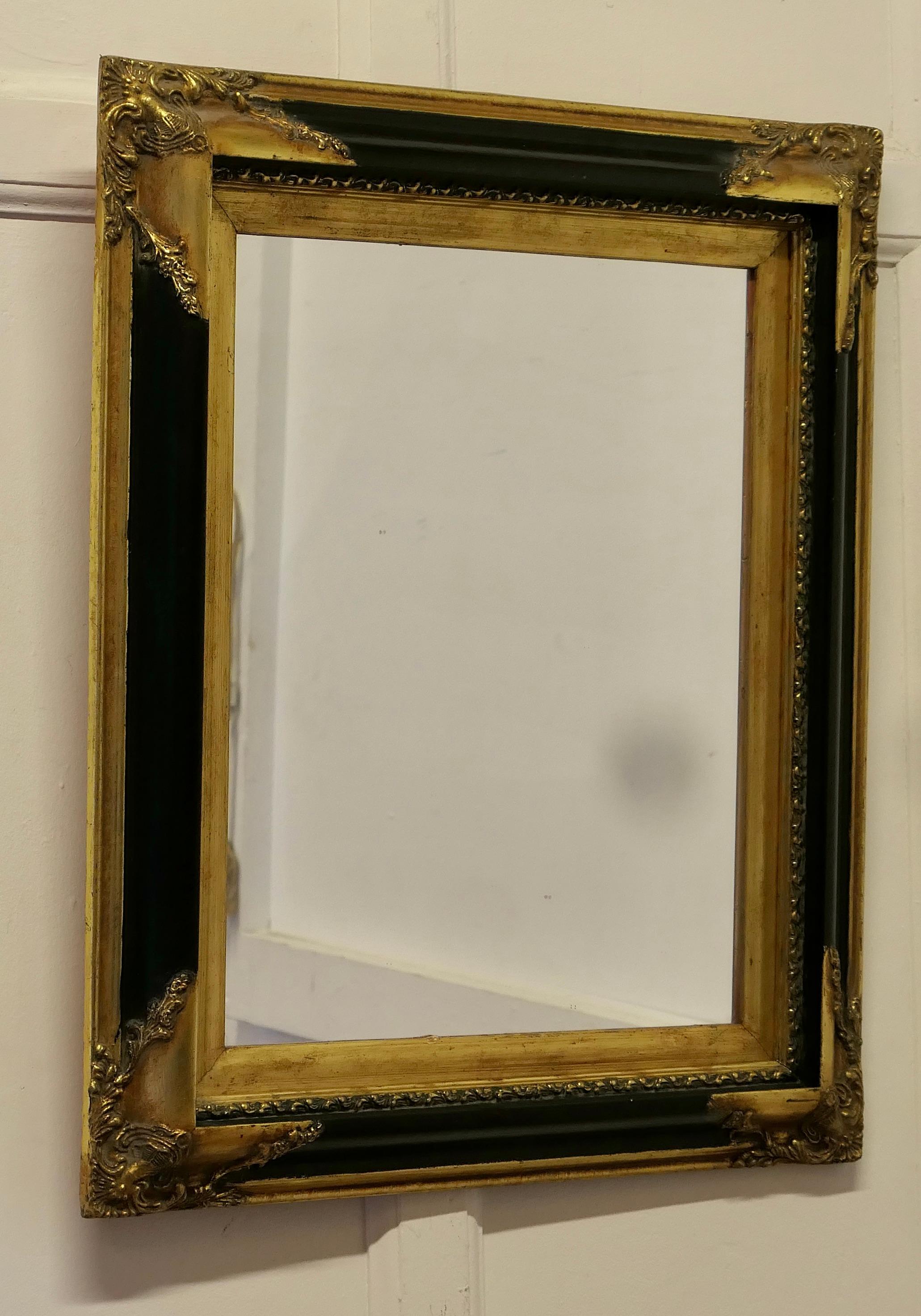 An Elegant Regency Gilt and Black Wall Mirror

This is a superb quality piece, the mirror has a rectangular looking glass which is set in a 4” wide deeply moulded frame detailed in Gold and Brass
All in good attractive condition
The mirror is 27”
