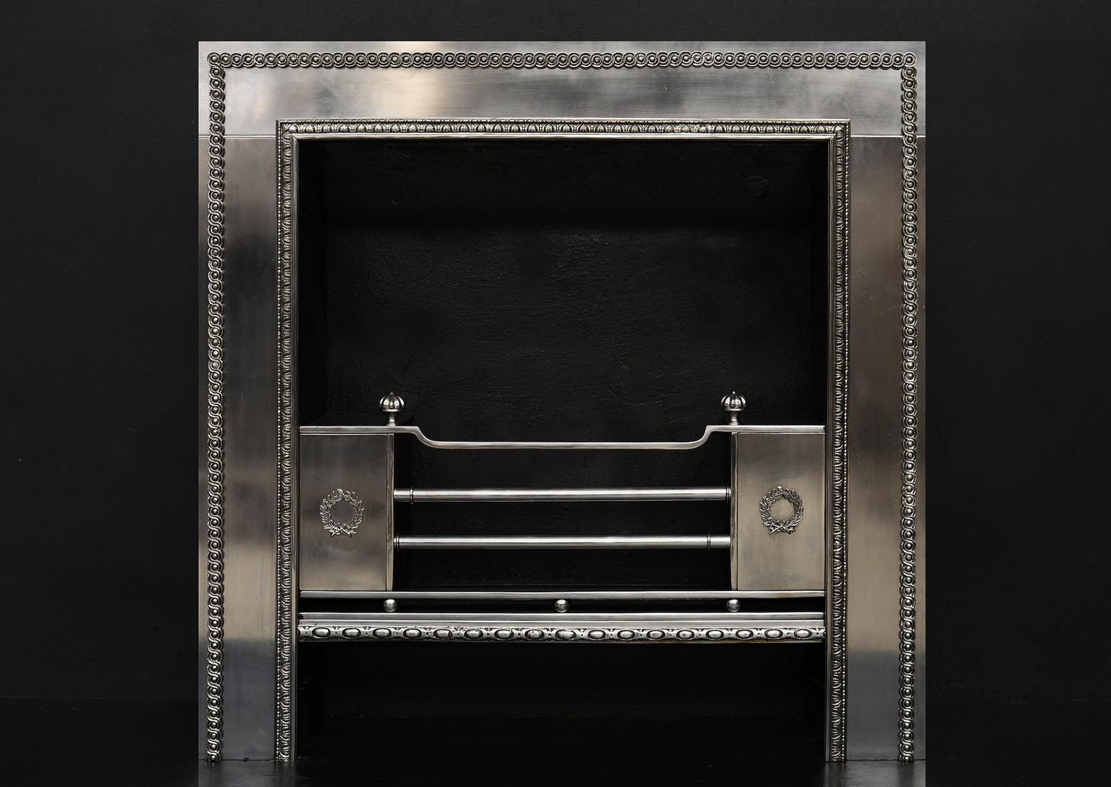 An elegant Regency style steel register grate with enrichments. Cast guilloche steel moulding to outer rim, and engraved leaf and pearl inner moulding. Laurel pattern to hob fronts. Modern.

Measures: Width at front: 1025 mm 40