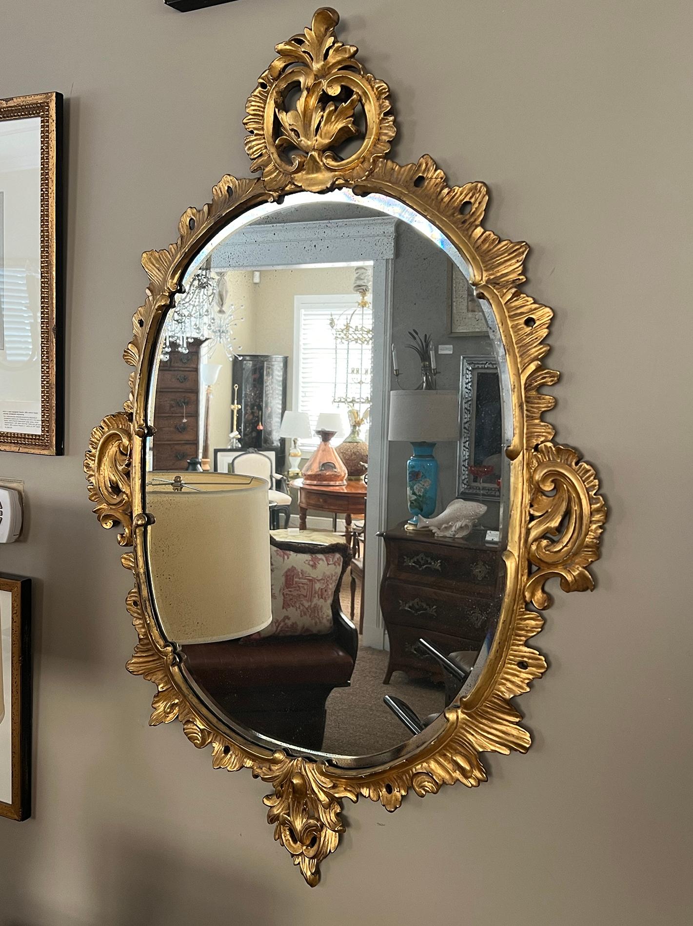 An Elegantly Carved French Louis XV Style Rococo Giltwood Oval Mirror In Good Condition For Sale In San Francisco, CA