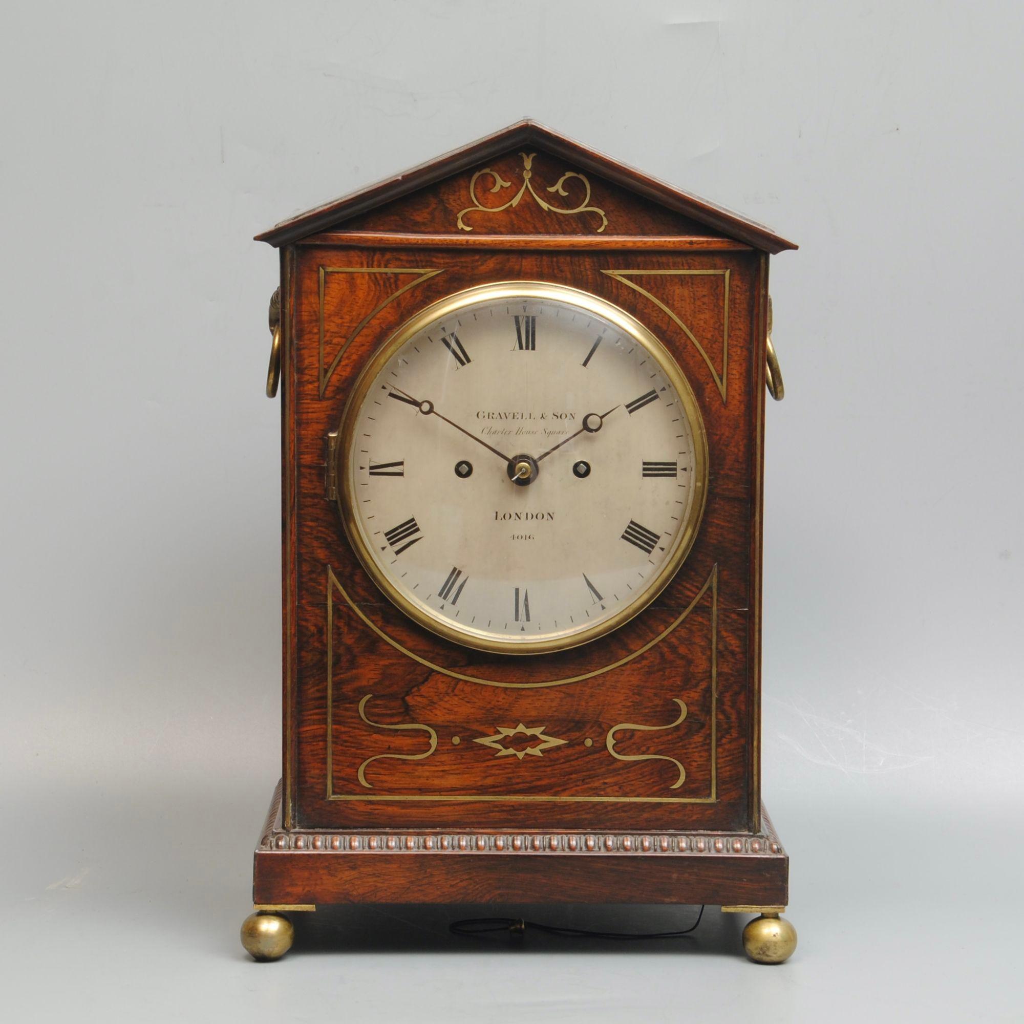 A fine early 19th century rosewood and brass inlaid bracket clock with a silvered dial, signed and numbered Gravell & Son, London 4016, original elegant hands. Also signed and numbered on the back plate of the 8 day movement. The elegant case with