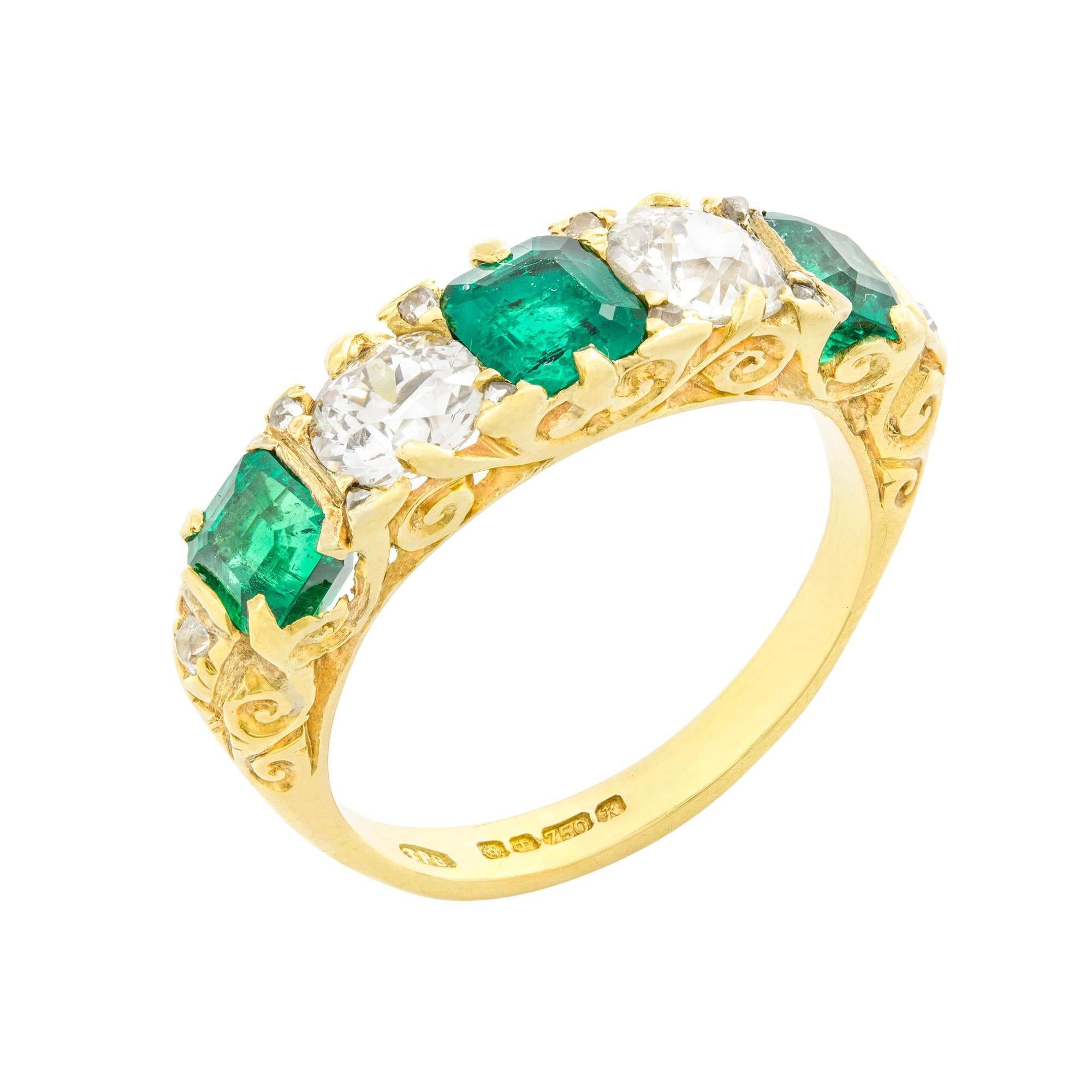 An emerald and diamond five-stone Victorian style ring, the three old octagonal-cut emeralds weighing 1.29 carats, accompanied by GCS report stating to be of Colombian origin, claw set between two old European-cut diamonds each estimated to weigh
