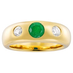 An emerald and diamond gold gyspsy-set ring