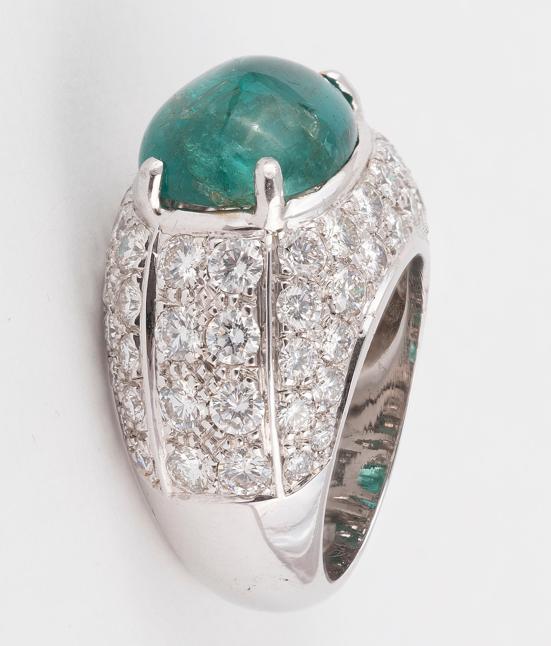Of bombé design, set with a cabochon emerald weighing approximately 6,5cts, accented by brilliant-cut diamonds approx. 3,50cts, maker's mark, Italy assay mark, ring size 7½