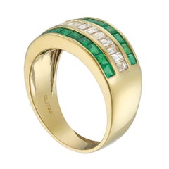An emerald and diamond three row ring