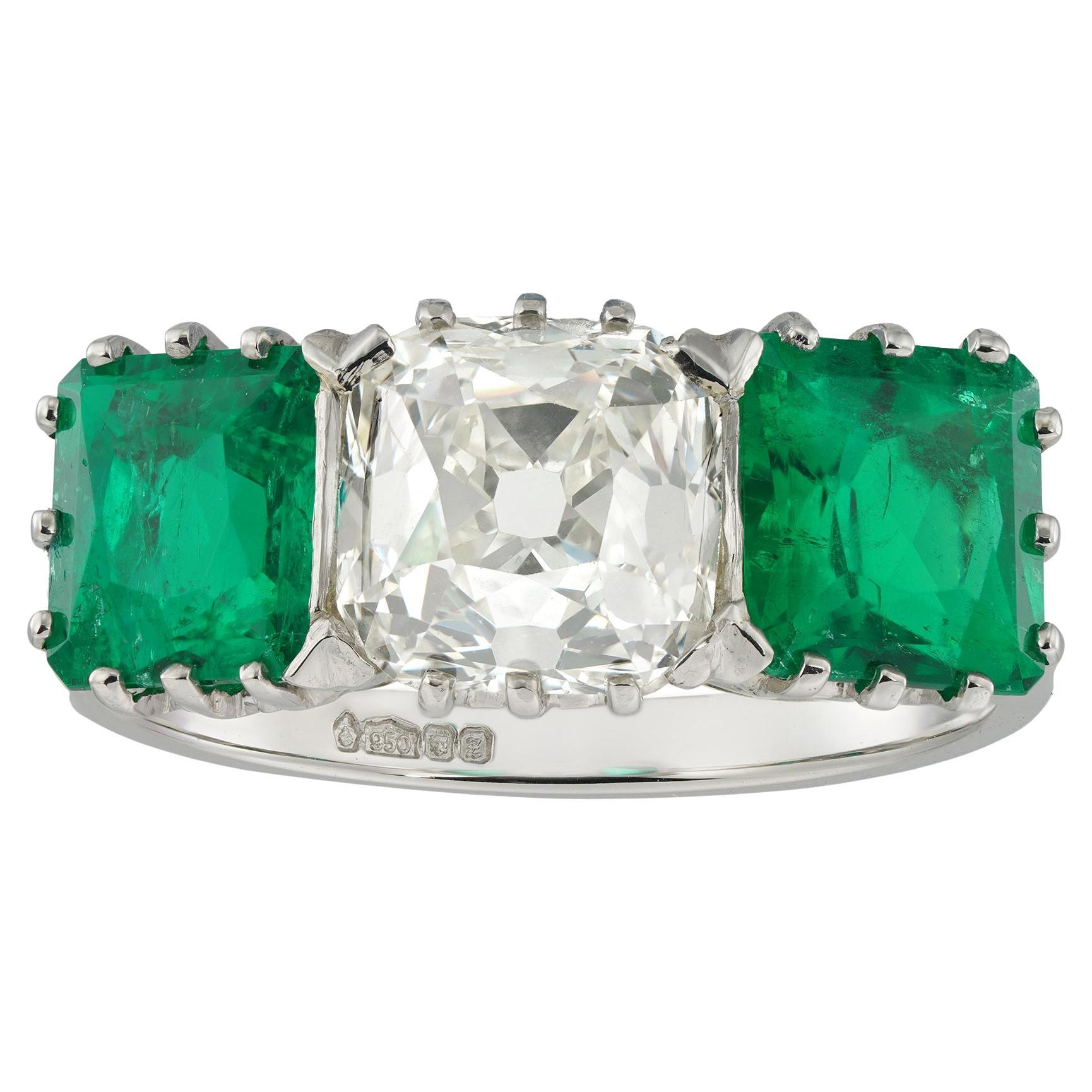 An emerald and diamond three stone ring For Sale