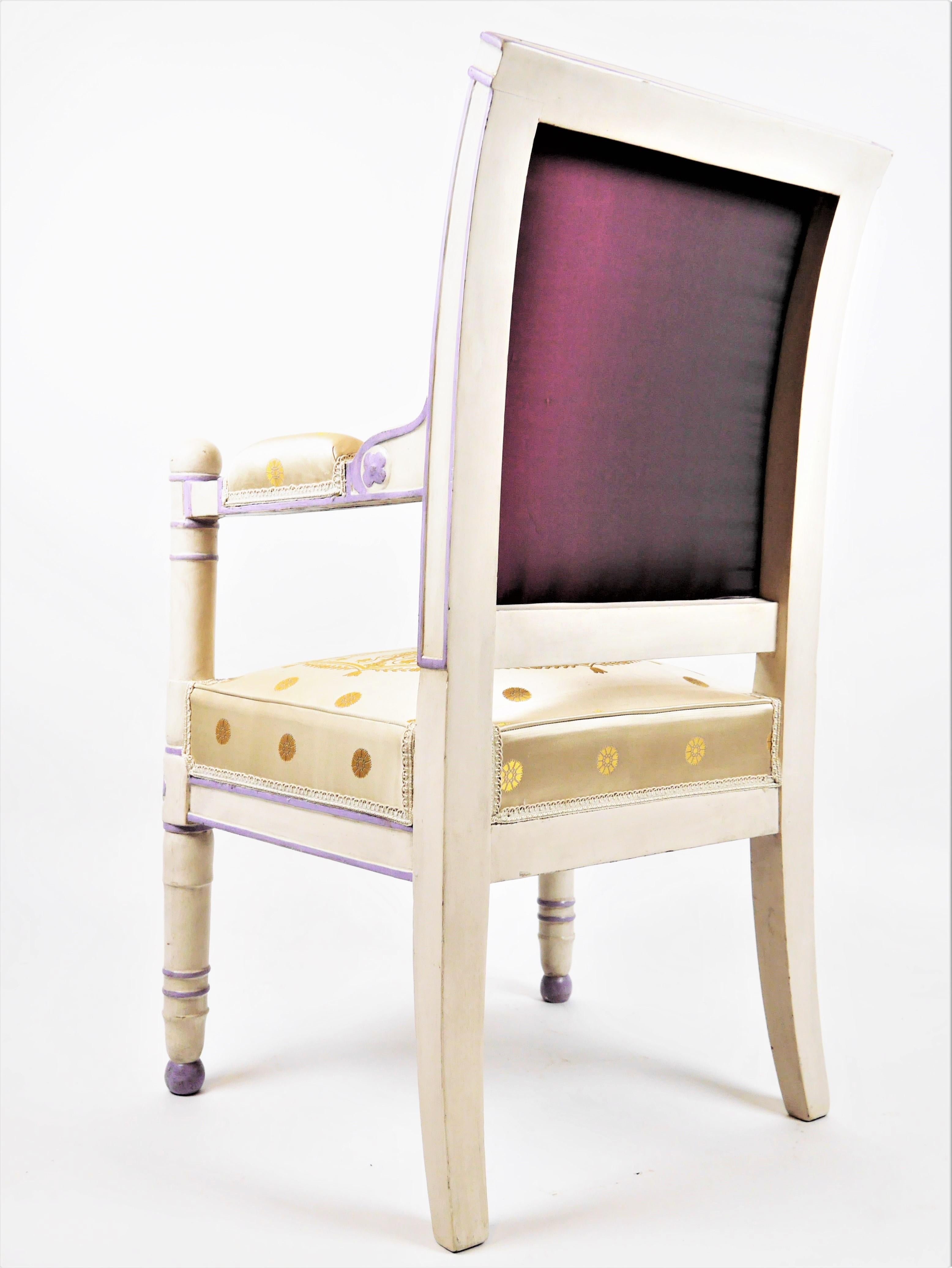 An empire armchair, curved back and carved flowers decoration in cream lacquered beech and rechampi in purple.
Numerous inventory numbers of the Palais de Rambouillet and Fontainebleau that prove us that the armchair comes from the Palace of