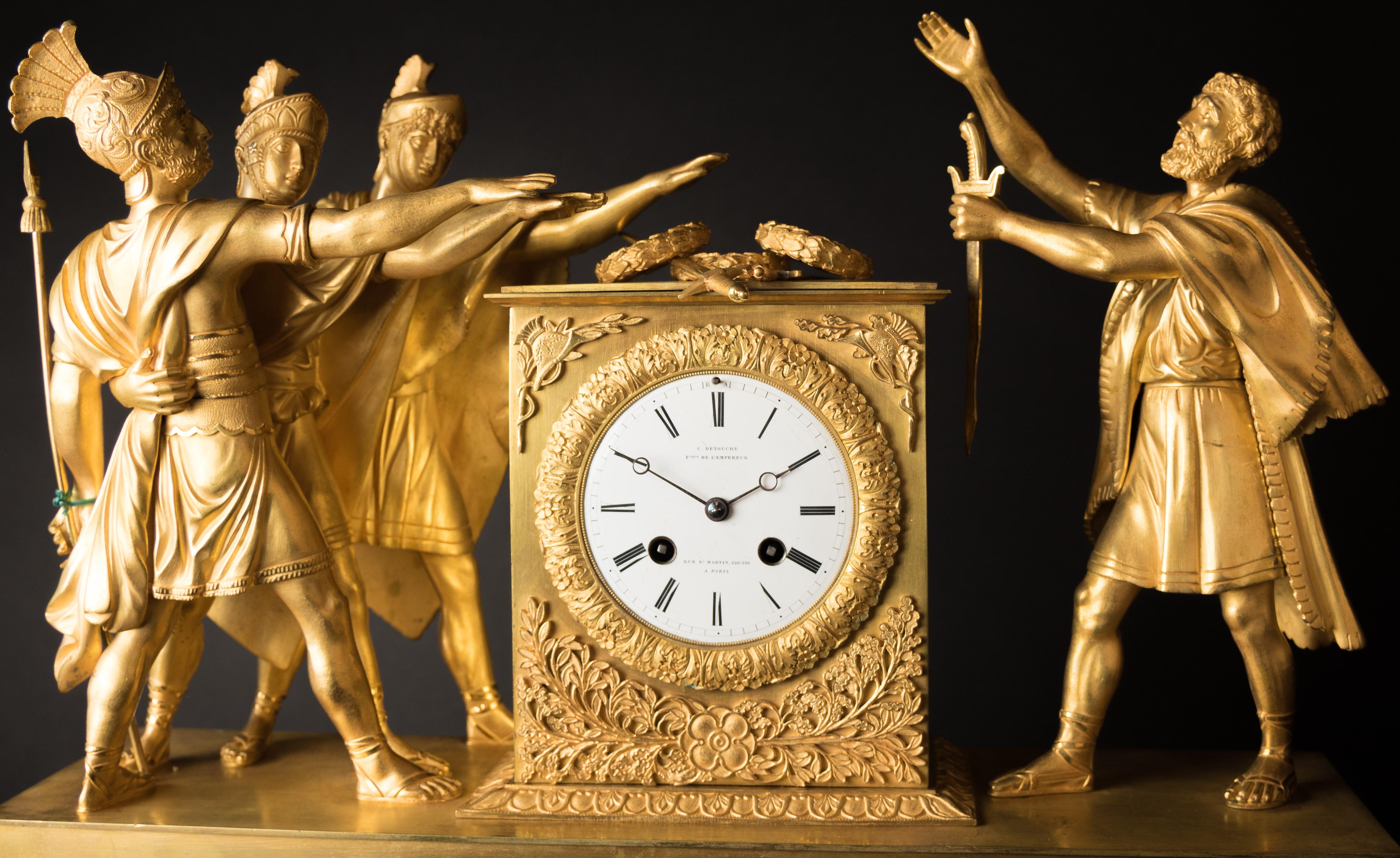 An Empire gilt and patinated bronze mantel clock. The dial signed 