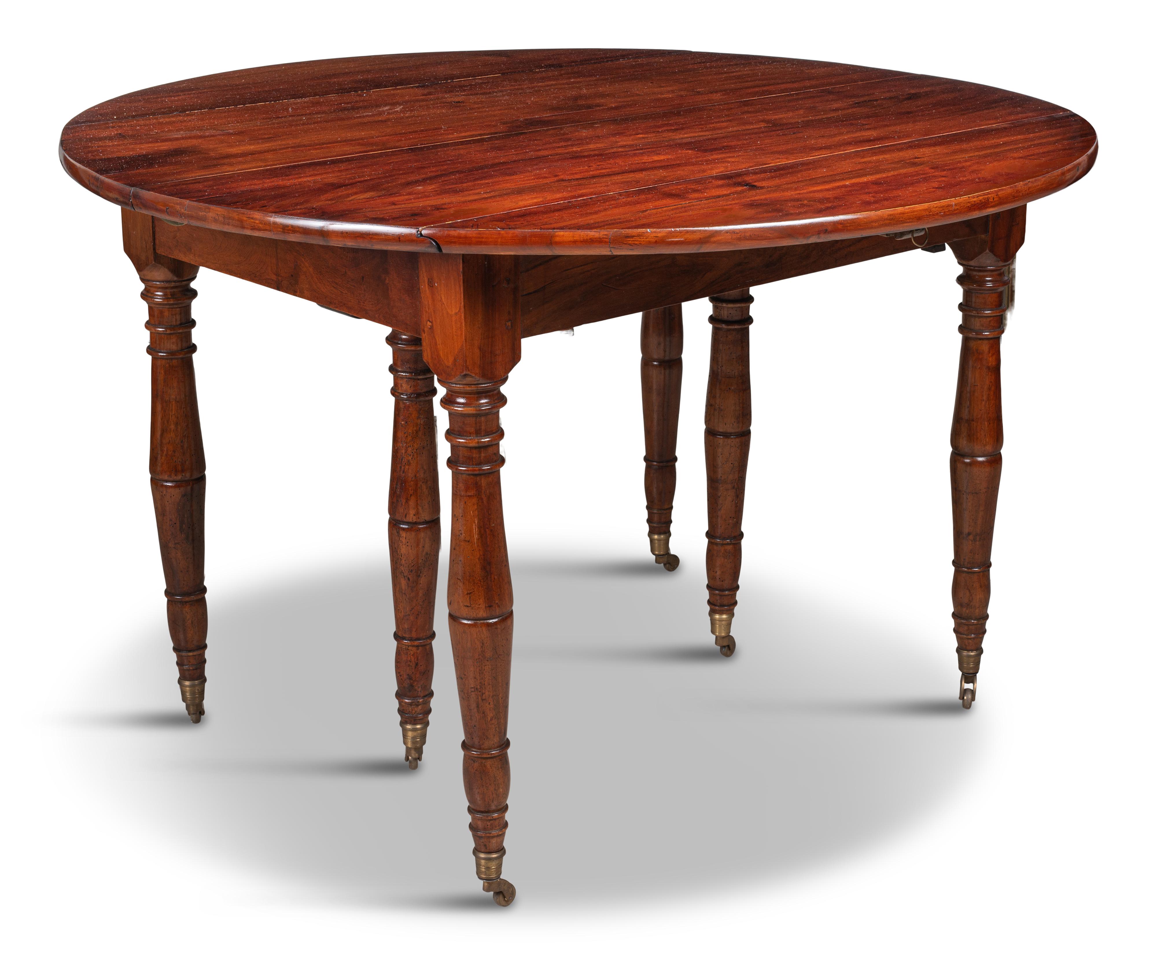 The oval top with hinged end flaps extending on baluster and ring-turned legs ending in brass caps and casters, with five later leaves.
For a similar model, see Christie's sale of October 20, 2005, lot 432 ($16,800).
The width in the dimensions is