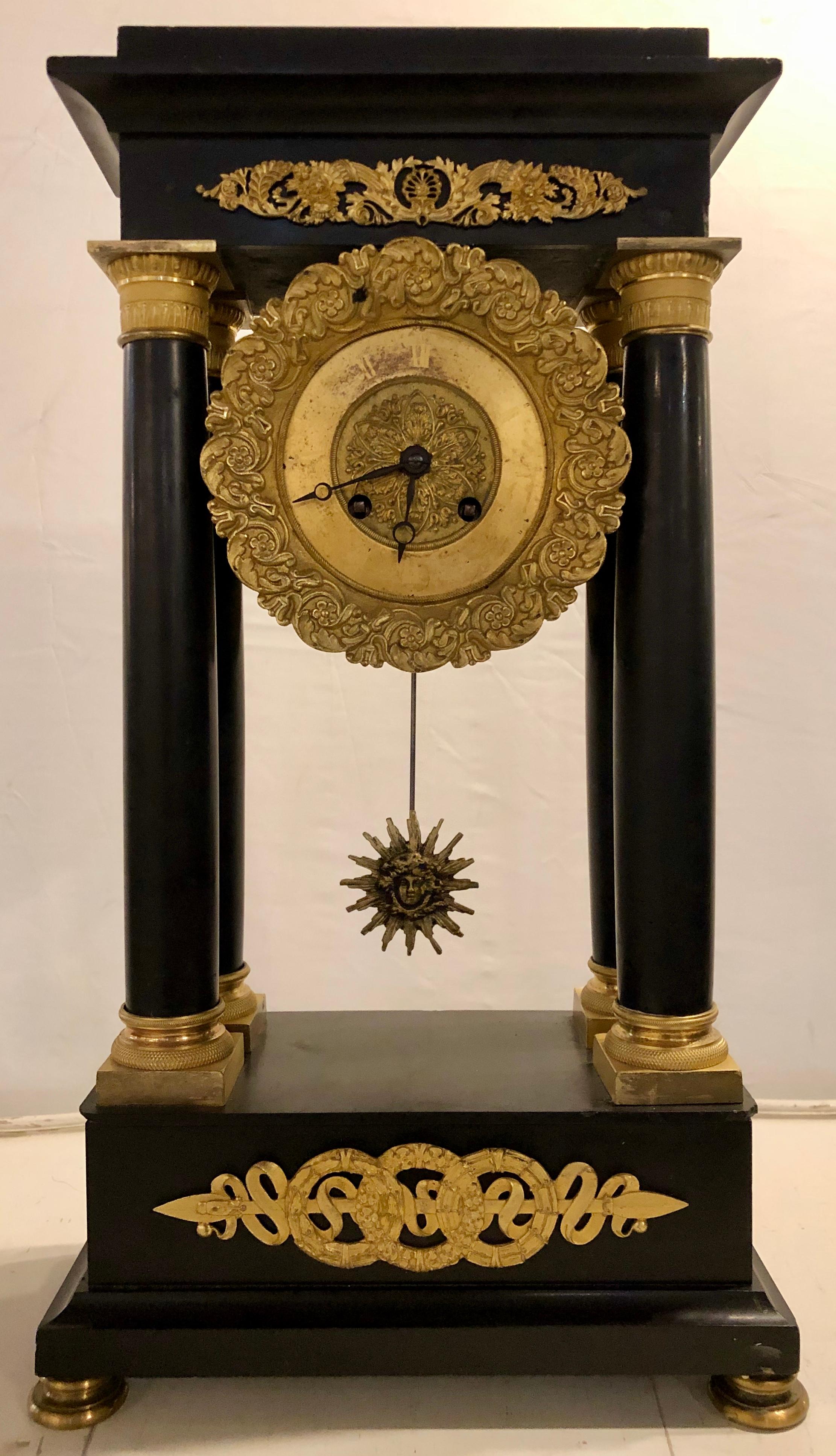 An Empire marble and bronze mantel clock. A fine bronze mounted and marble column form mantle clock. At the time of the listing this clock is working fine.