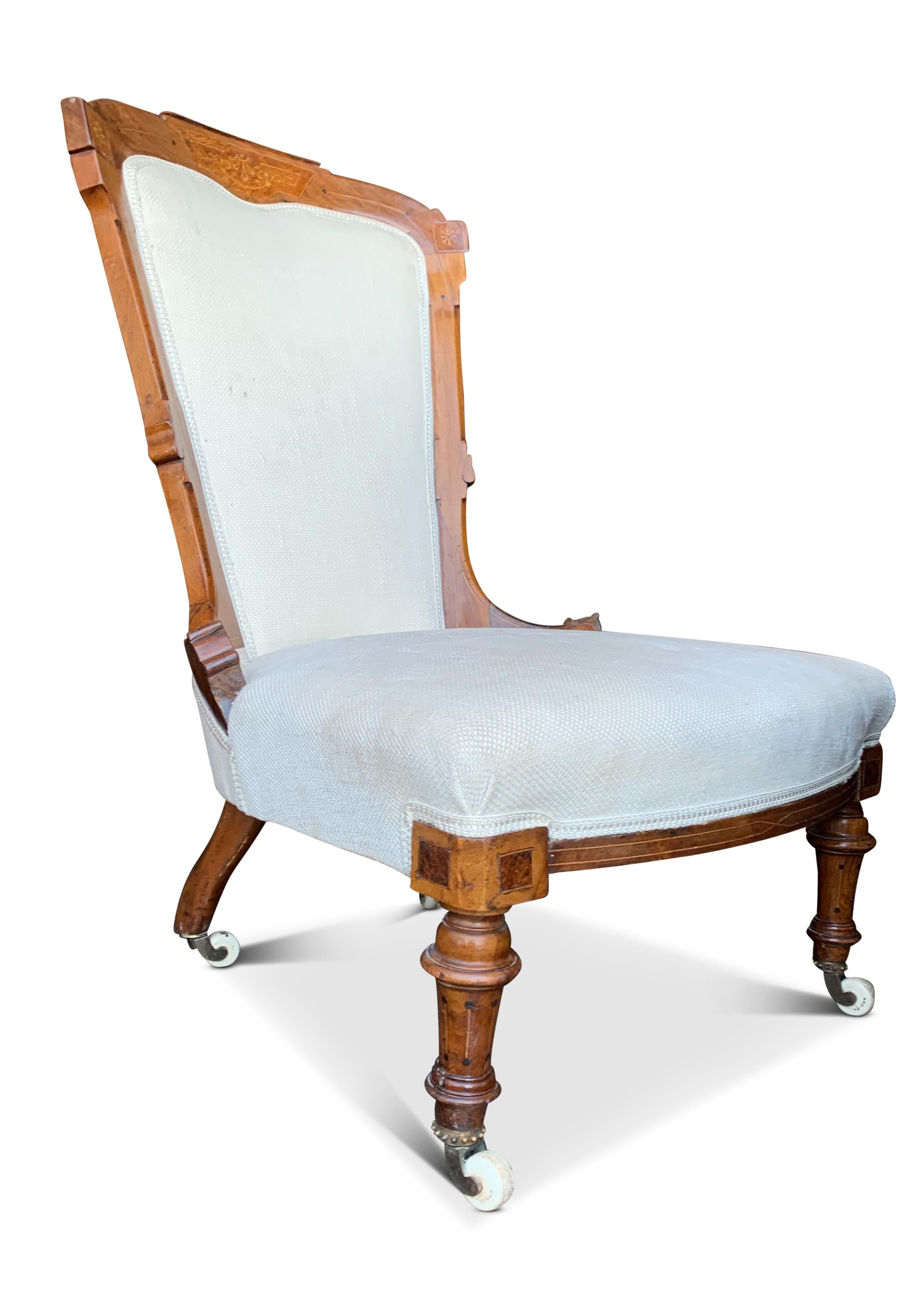 19th Century An Empire Walnut Upholstered Salon Chair With Decorative Inlay & Ceramic Castors For Sale