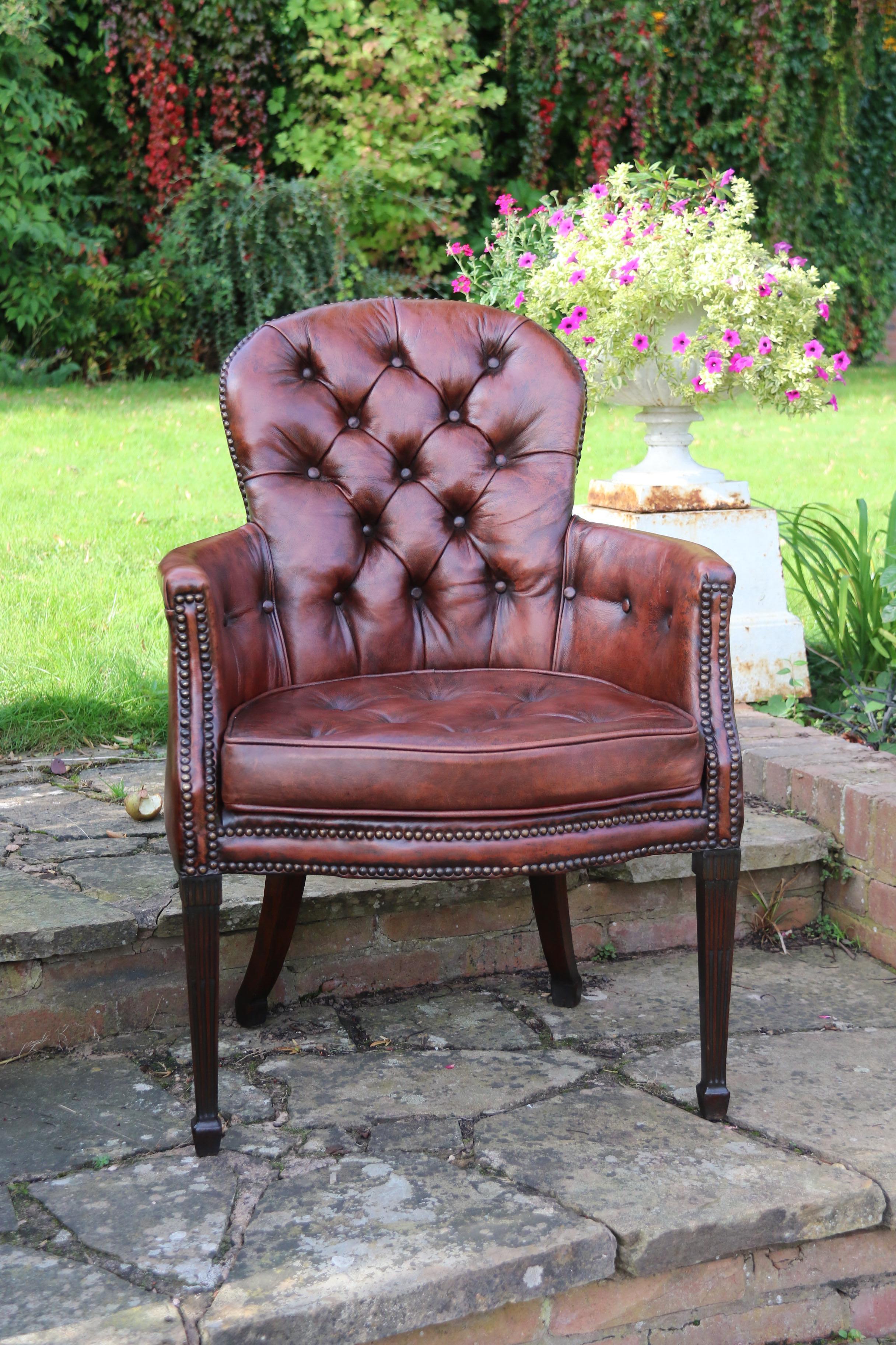 This very stylish rare armchair dates to the late 18th century. It stands on square tapered front legs with spade feet which are decorated with carved fluting and reeding. The rear ones have a similar square form with a generous and elegant back