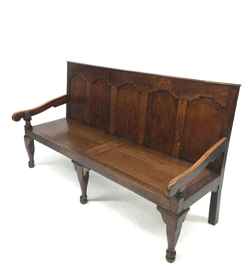 An English 18th century oak settle, hall bench

With fielded paneled back and armrest

The dimensions are 103 cm high, 183 cm wide and the depth is 68 cm
Seat height is 43 cm
The weight is ca. 40 kilos.