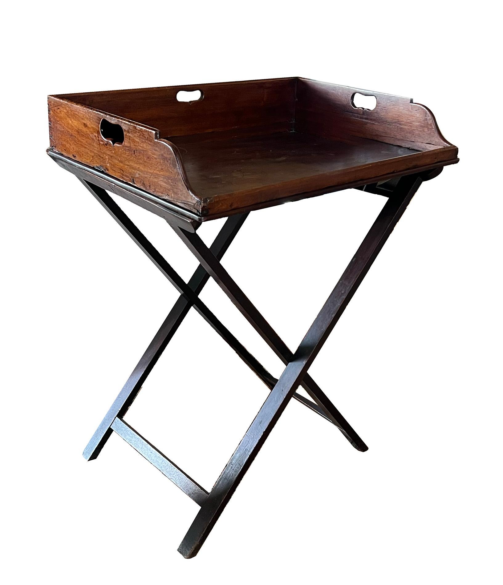 the rectangular tray with a deep gallery pierced with shaped handles; raised on a later collapsible x-frame stand; perfect design for a bar stand