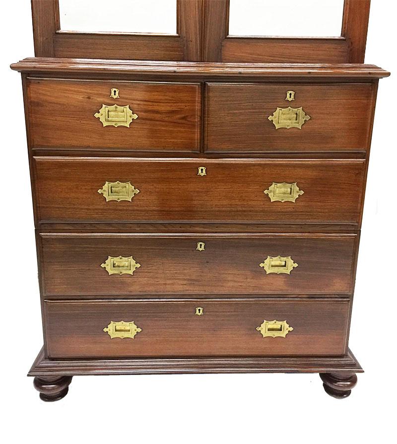 An English 19th century mahogany linen cupboard press

An English 19th century mahogany linen cupboard with a curb with mirror doors with interior of a shelf and 2 drawers. 
A secret compartment is hidden behind these drawers. 
The below part