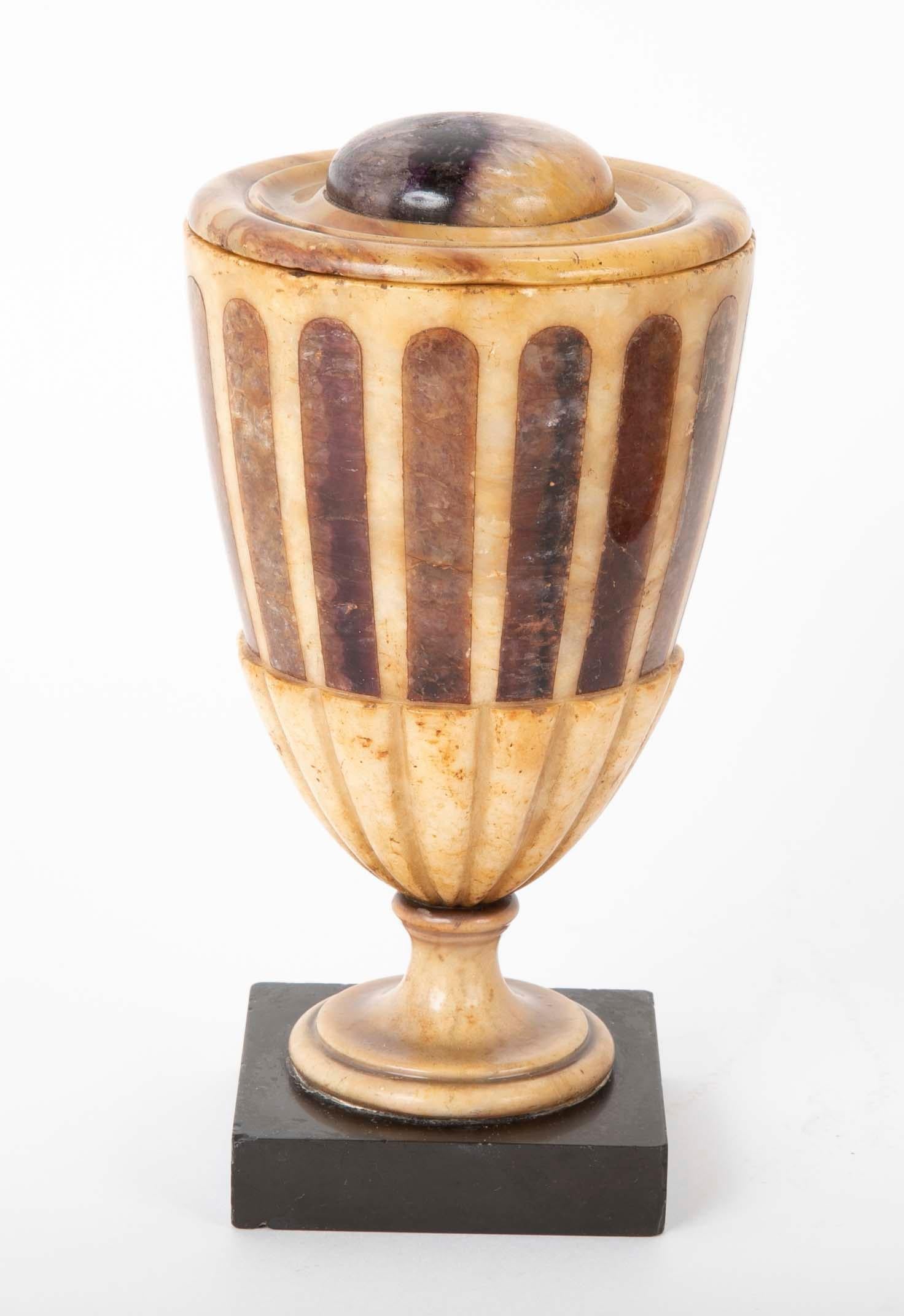 An alabaster urn and cover inlaid with blue John on square slate base. English, circa early 19th century.