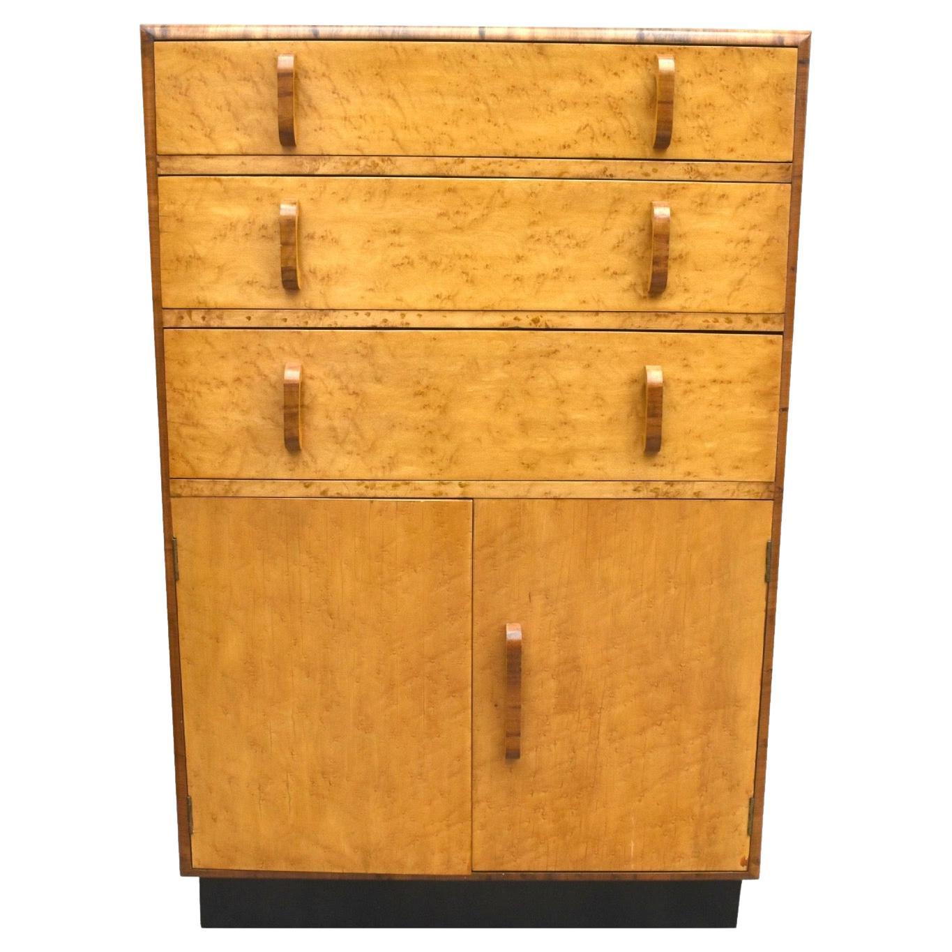 For your consideration is this English, Art Deco, blonde Birds Eye Maple two-door, three drawer single-piece tallboy, raised on an ebonised plinth, circa 1930 and in excellent original condition. Not only does this tallboy look the part but it's