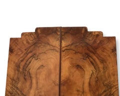 An English Art Deco single figured walnut wardrobe on stepped plinth