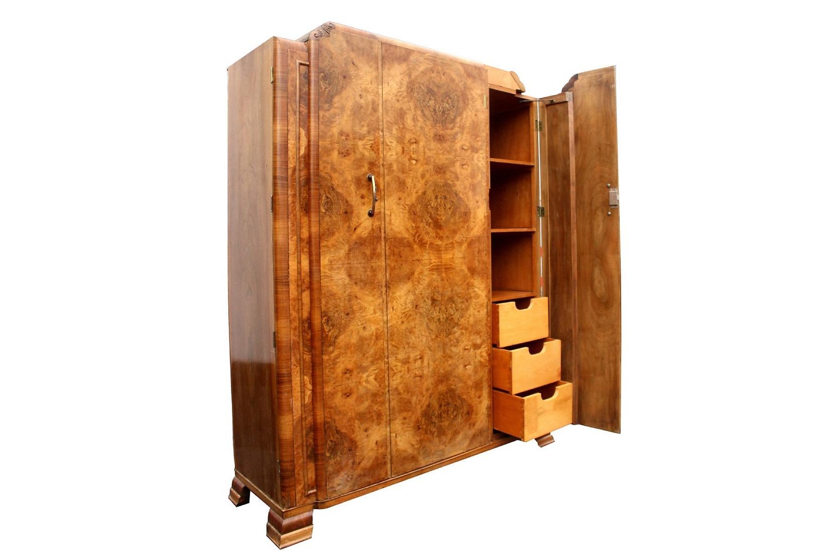 For your consideration is this extremely stylish English Art Deco heavily figured Walnut three-door wardrobe, dating to the 1930's with all original fixtures and fittings. Not only does this wardrobe look the part but it's extremely functional too
