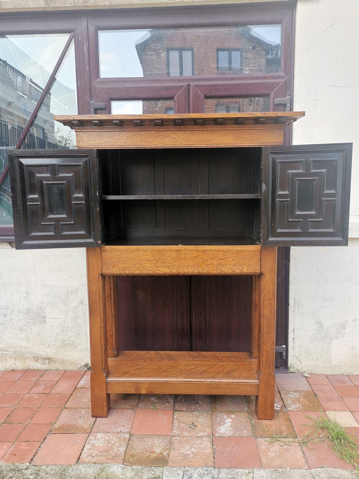 Liberty & Co . Attributed.
A super quality crafts man-made English Arts and Crafts style oak court cupboard with a flat top making a useful display area, a projecting cornice with an array of shaped supports, a central pair of panelled doors made