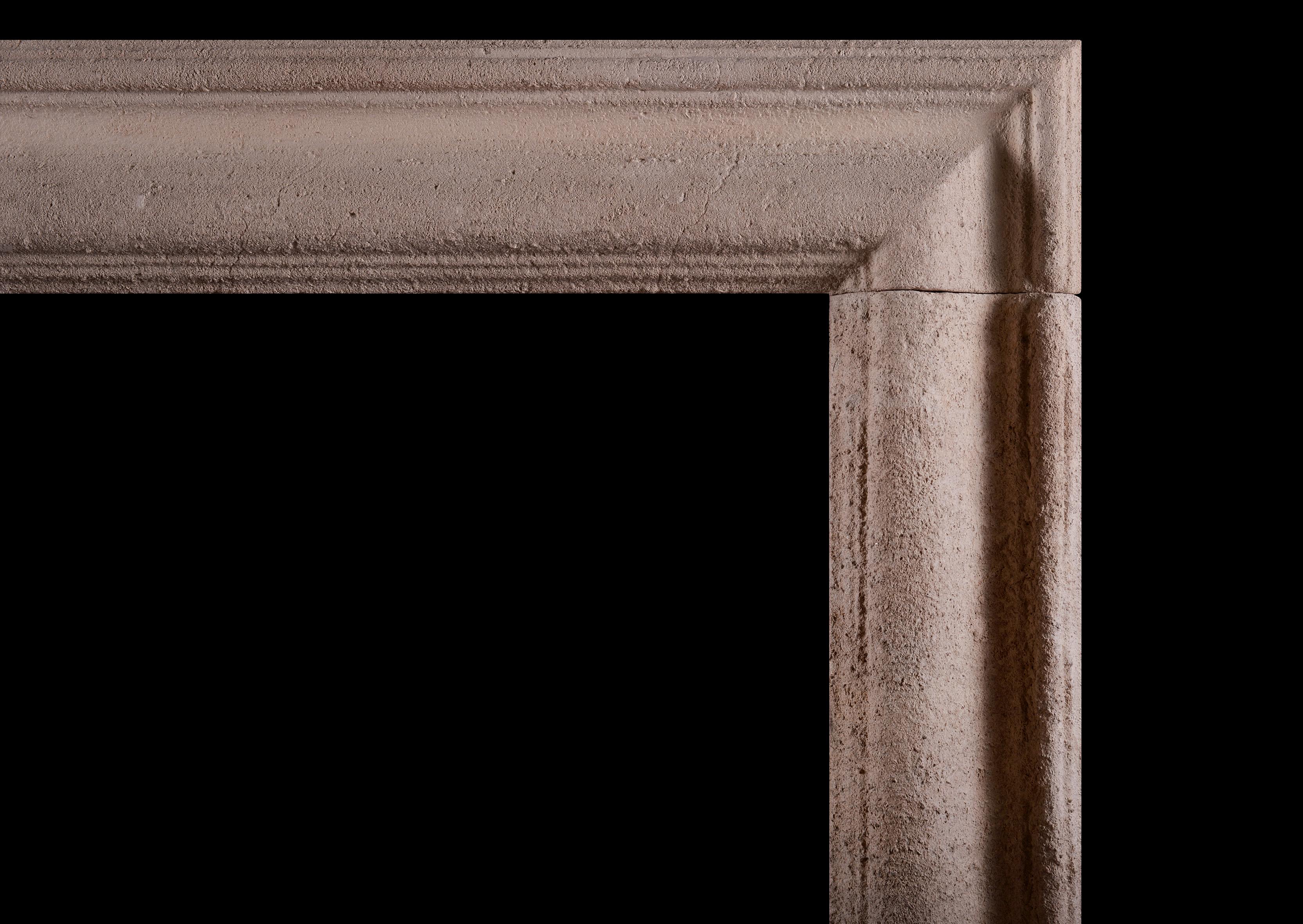An English bath stone fireplace. The moulded jambs and frieze with rustic patina. Circa 1900. 

Measures: Shelf width: 1383 mm 54 ½
